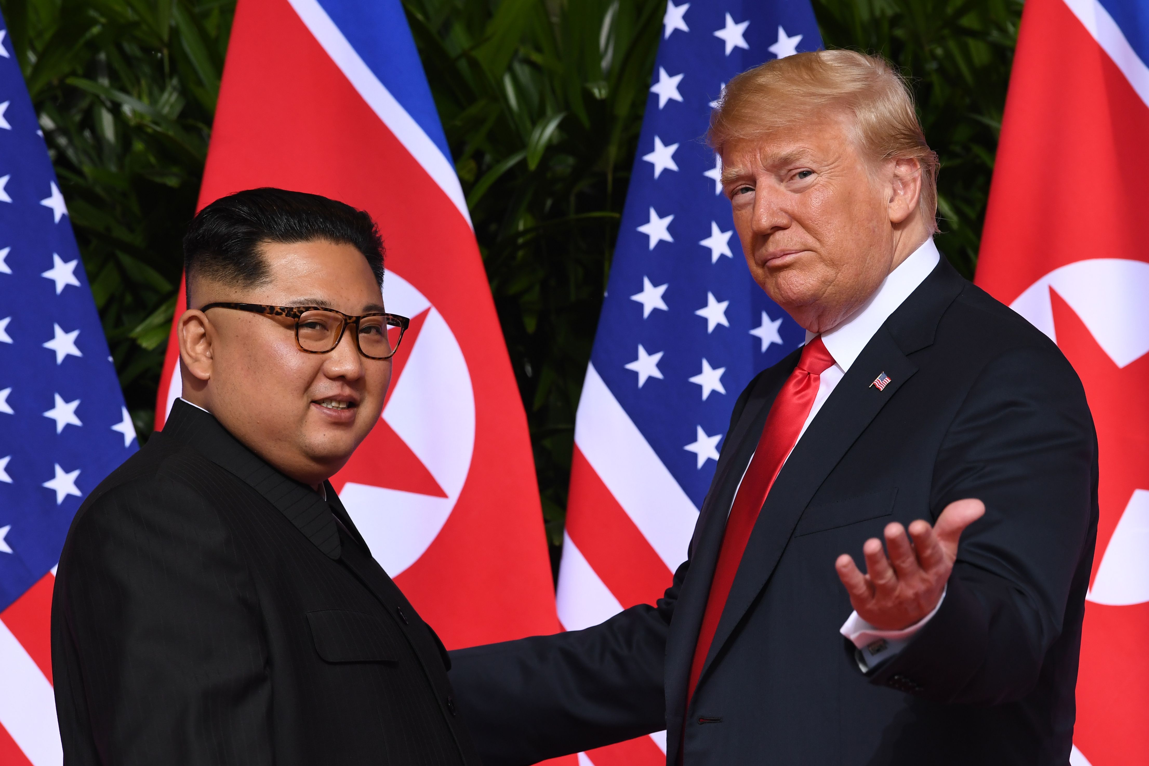 President Donald Trump (R) gestures as he meets with North Korea's leader Kim Jong Un (L) at the start of their summit in Singapore on June 12, 2018. (Saul Loeb—AFP/Getty Images)