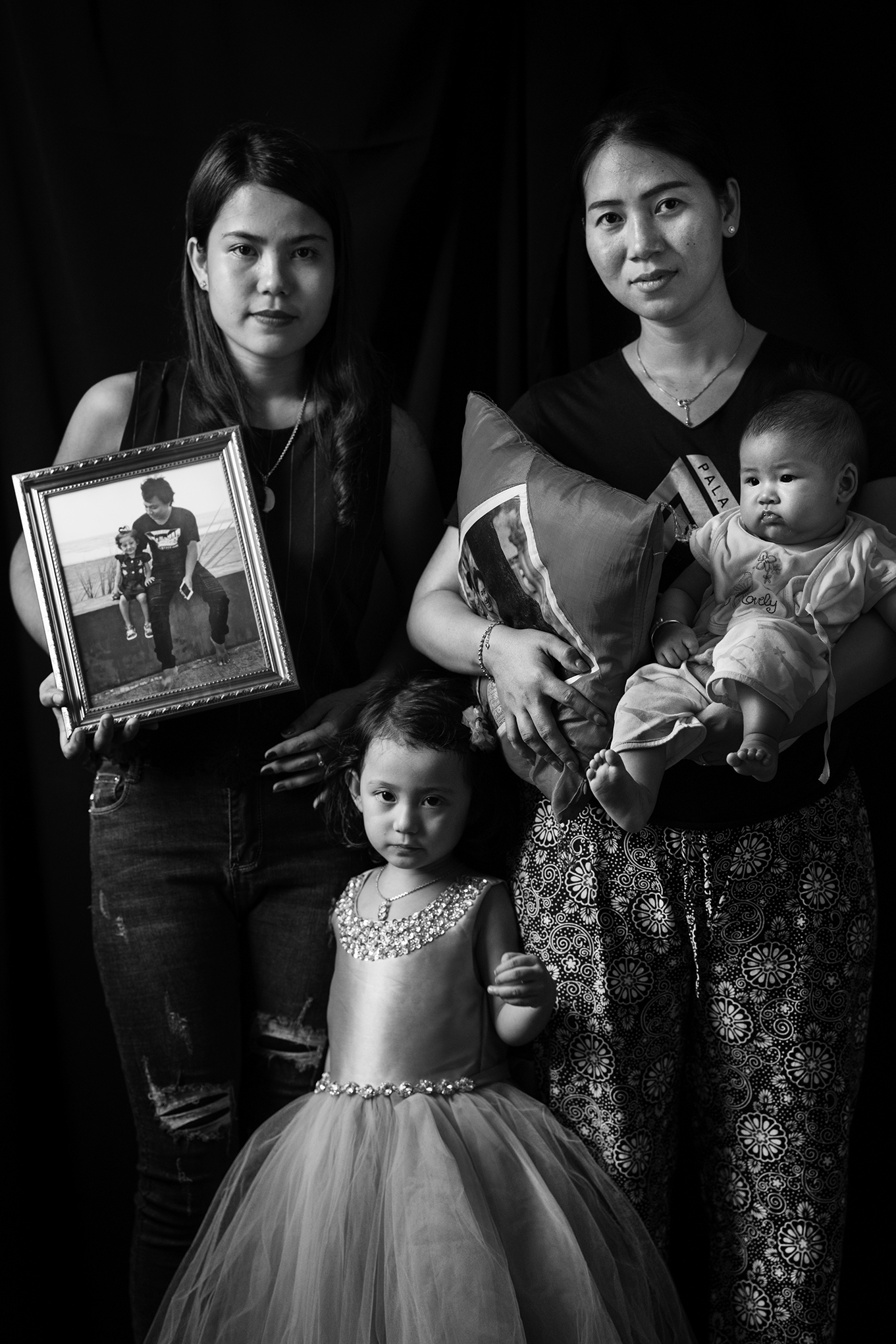 From left to right: Chit Su Win (Kyaw Soe Oo’s wife), Pan Ei Mon (Wa Lone’s wife), Thet Htar Angel (Wa Lone’s baby), Moe Thin Wai Zin (Kyaw Soe Oo’s daughter) in Pan Ei Mon’s home in Yangon, Myanmar on Dec. 3. (Moises Saman—Magnum Photos for TIME)