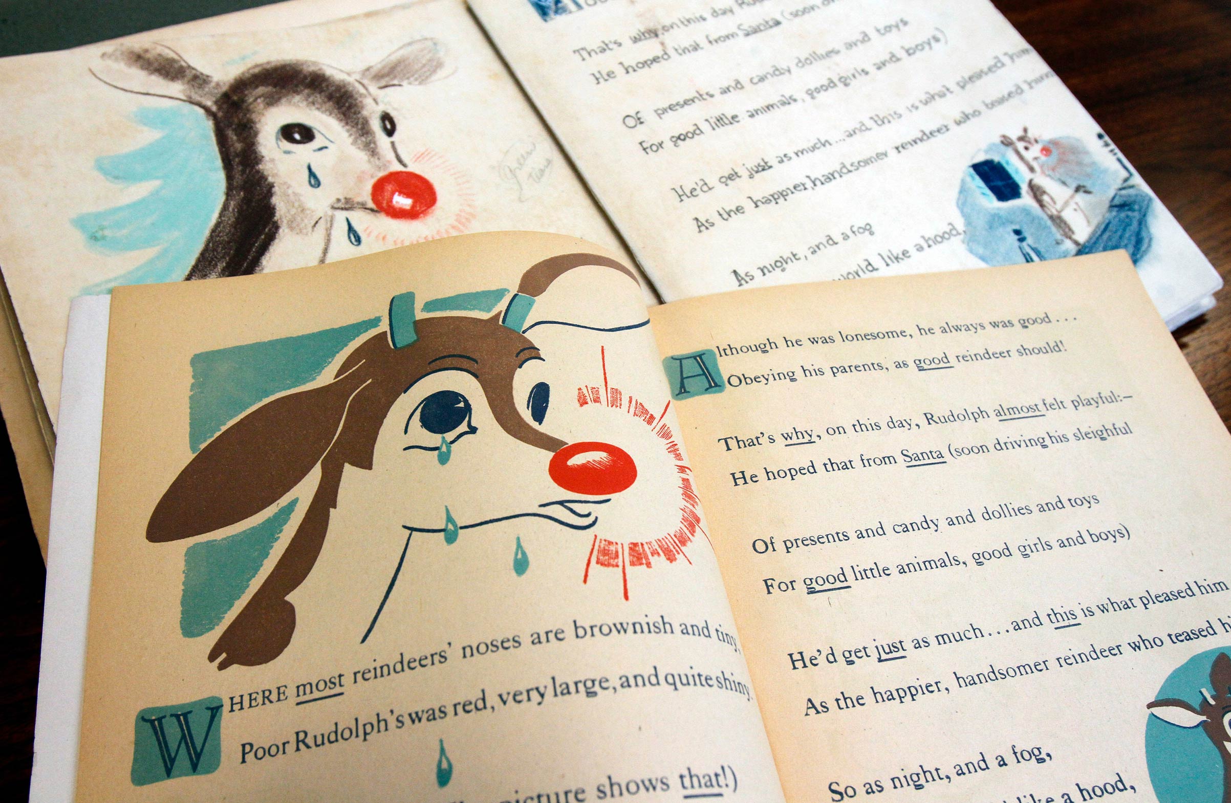 A first edition of "Rudolph, the Red-Nosed Reindeer", bottom, and an original layout, top, on Dec. 20, 2011, at Dartmouth College in the Rauner Special Collections Library in Hanover, N.H. (Toby Talbot/AP—Shutterstock)