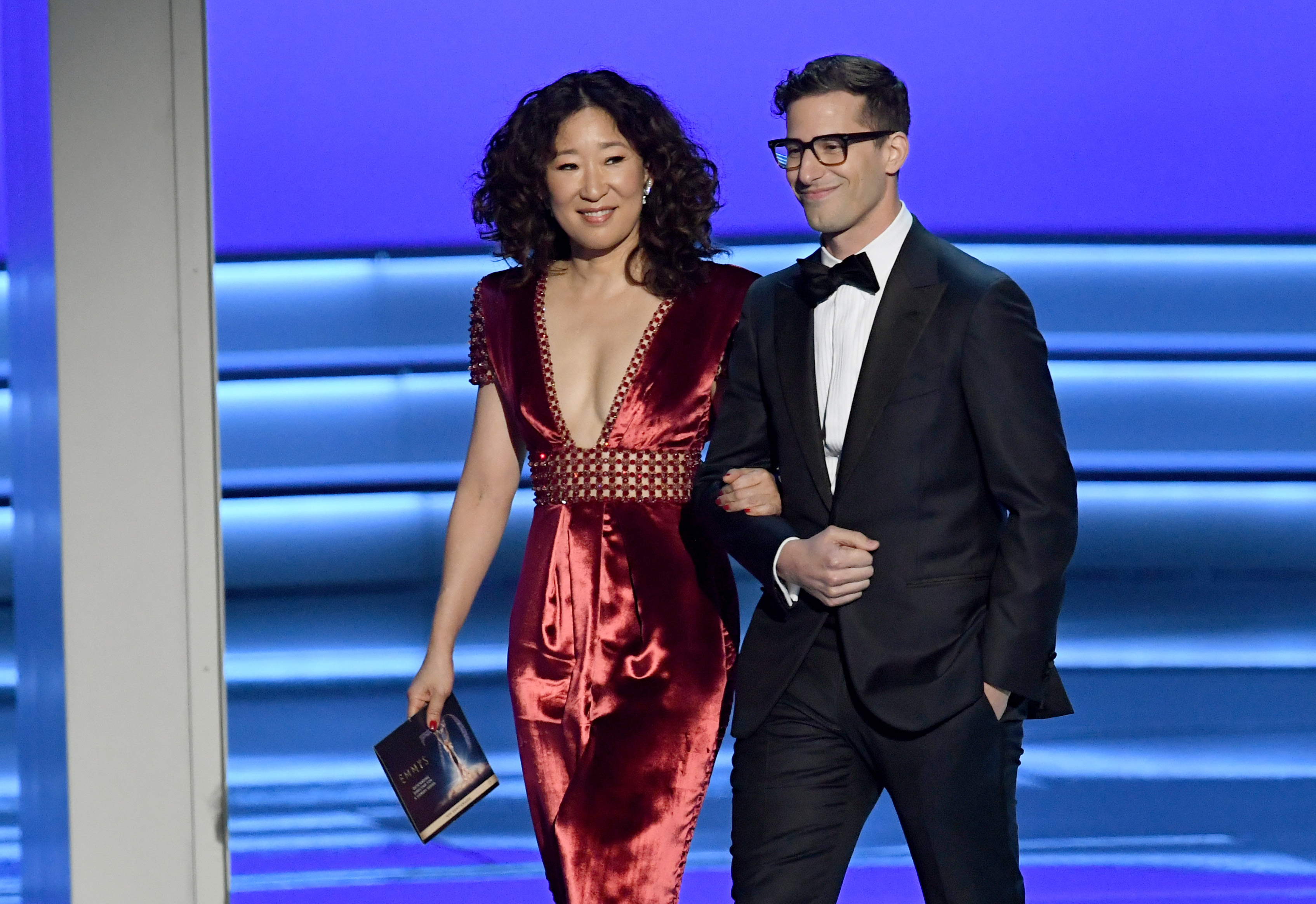 Sandra Oh (L) and Andy Samberg walk onstage during the 70th Emmy Awards at Microsoft Theater on September 17, 2018 in Los Angeles, California. (Kevin Winter—Getty Images)