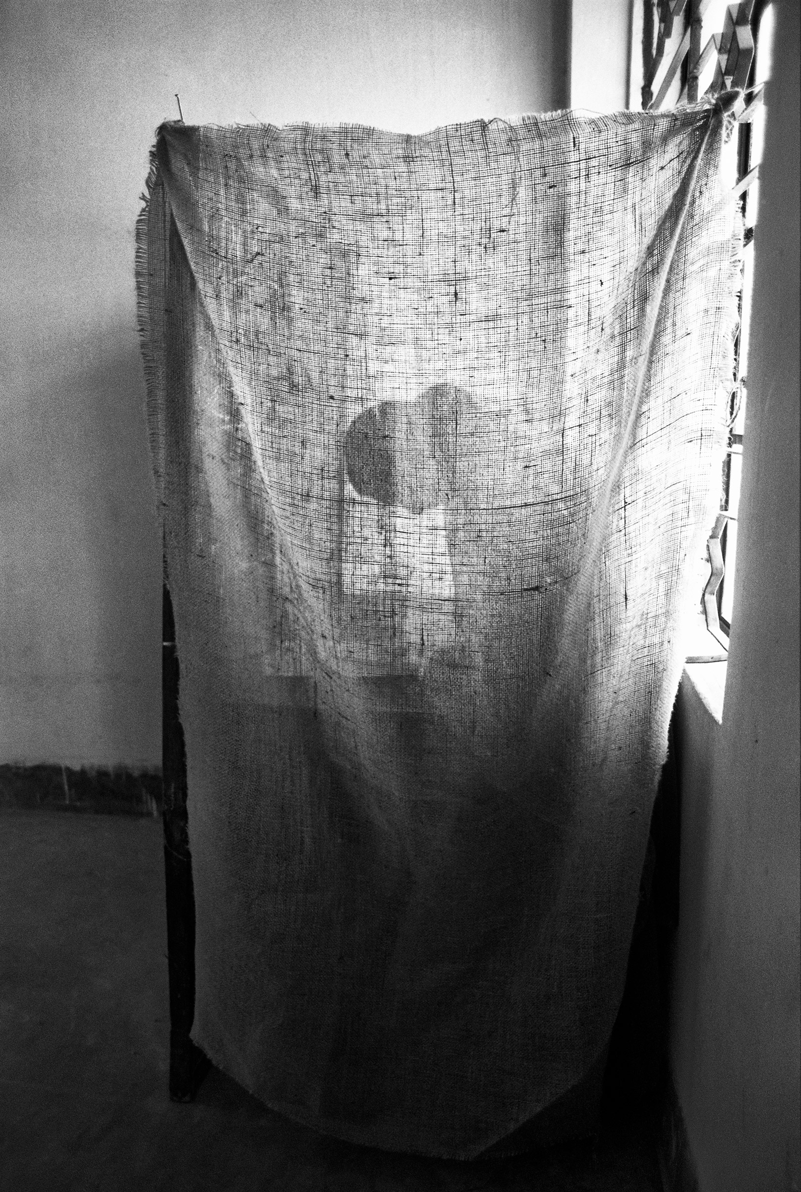 A woman in Lalmatia casts her vote behind a makeshift screen after the removal of Ershad, during the first free and fair election in Bangladesh in 1991. (Shahidul Alam—Drik)
