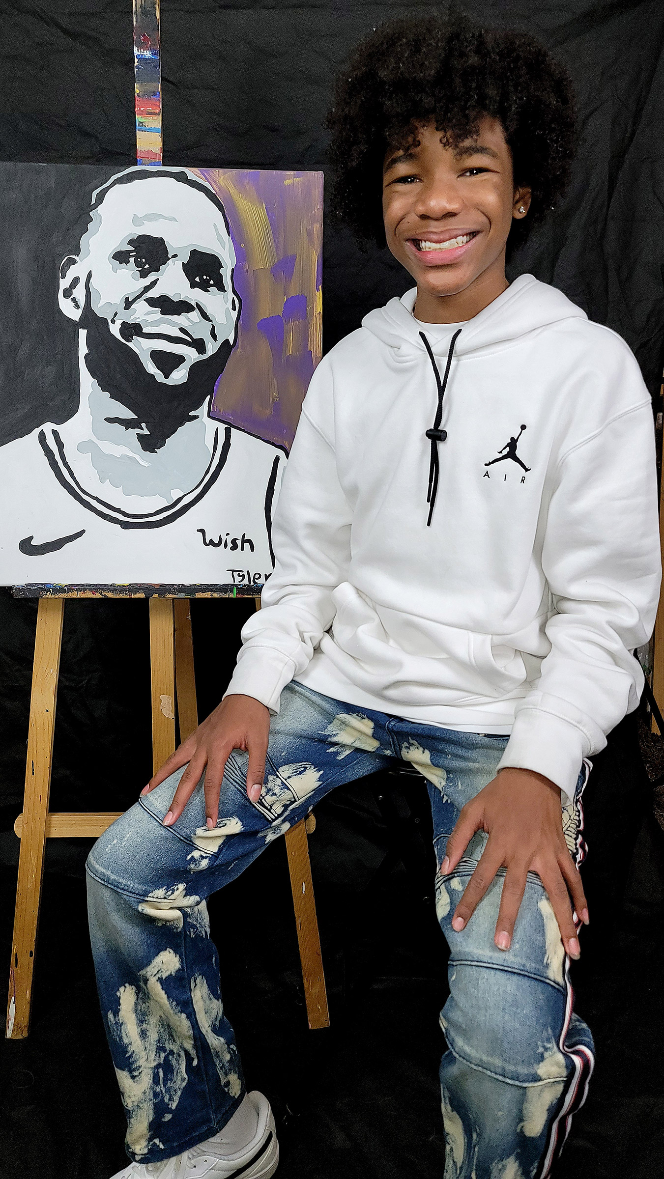 Tyler Gordon, 14, with his painting of Athlete of the Year LeBron James (Courtesy Nicole Kindle)