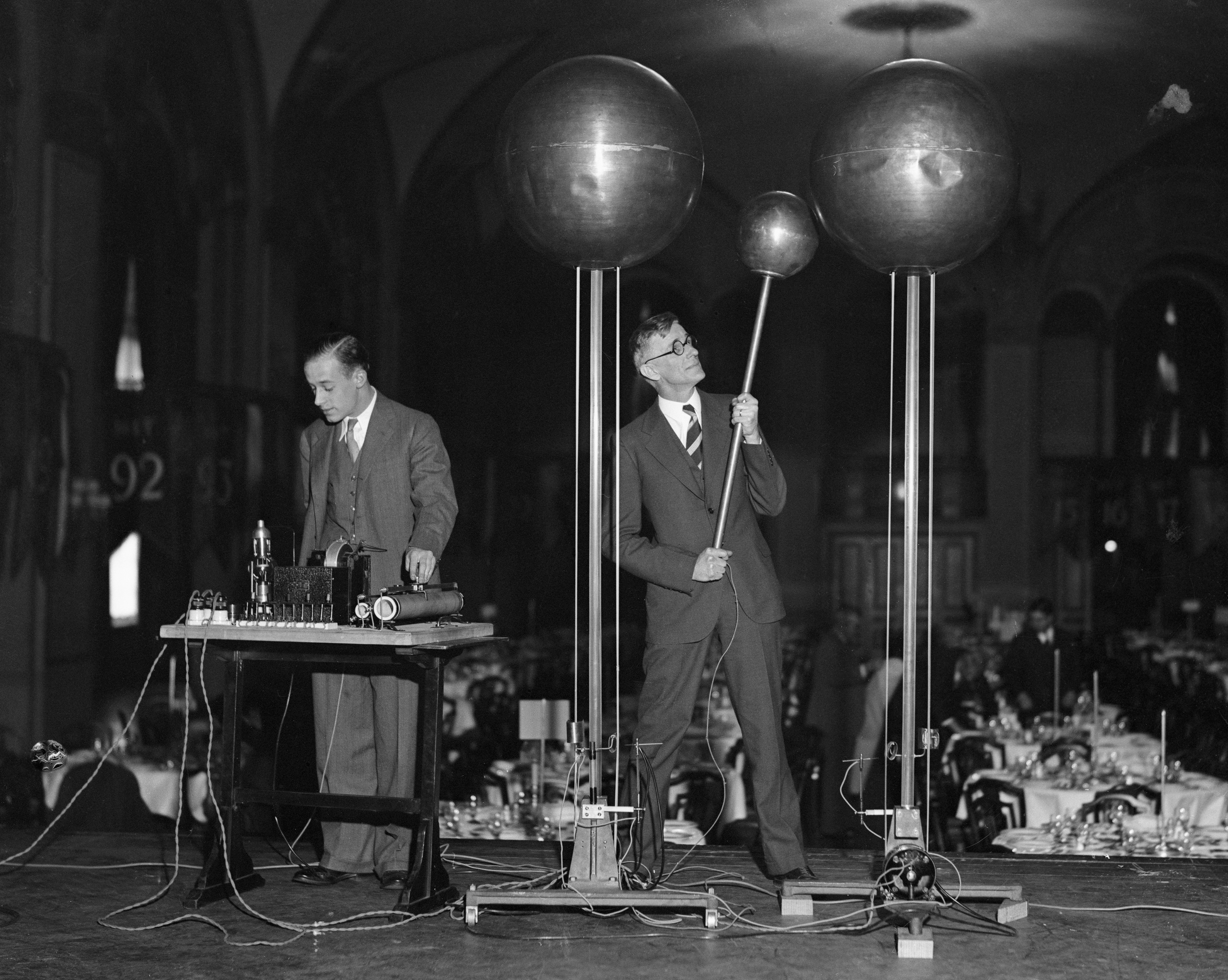 Dr. Vannevar Bush, right, and E.S. Lamar demonstrate the Dr. Robert Van De Graf 1,500,000 volt generator at the annual Dinner of Technology Alumni in the Copley Plaza. The generator is said to be capable of producing a shock of 10,000,000 volts. (Bettmann Archive/Getty Images)
