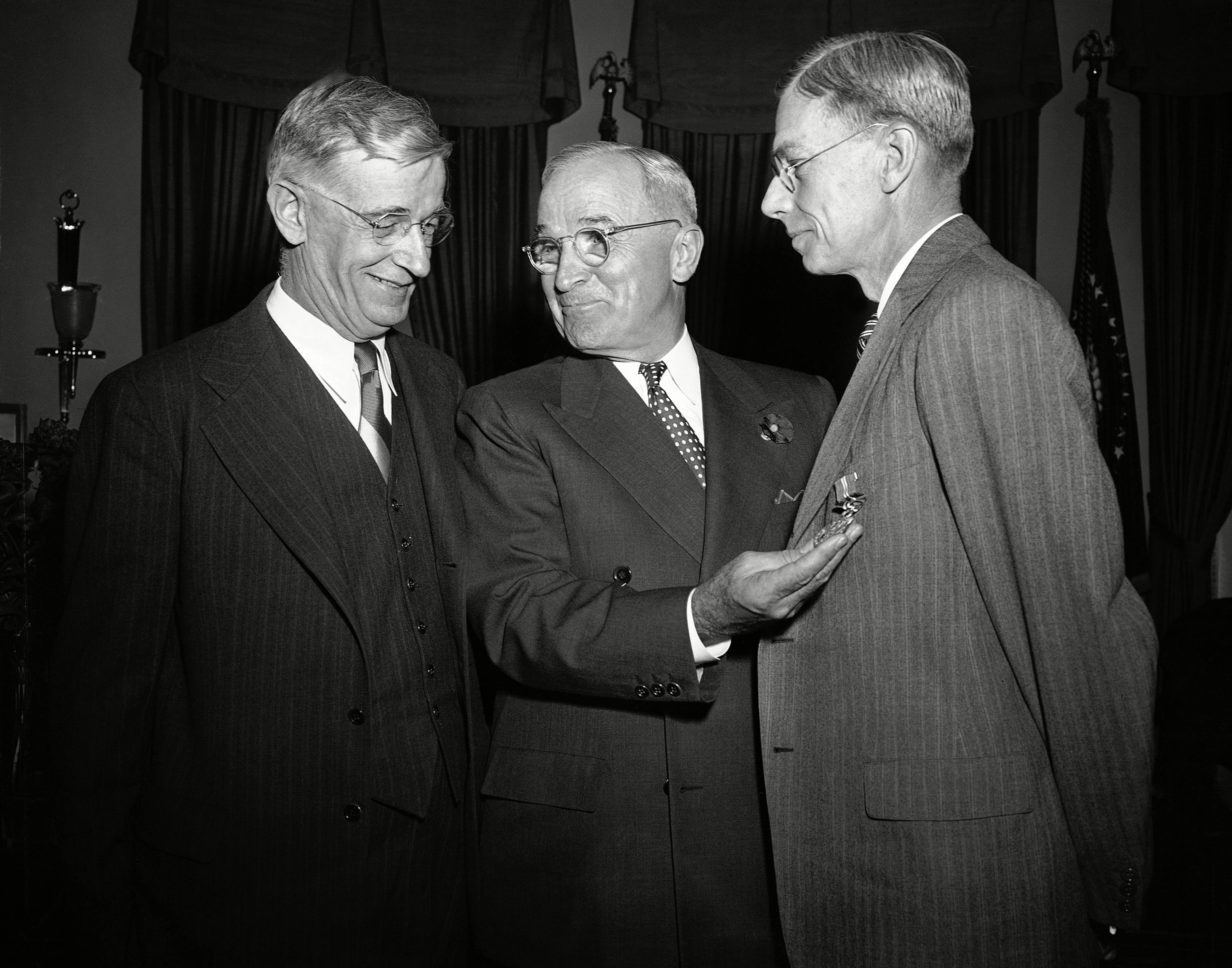 President Harry Truman, center, presents the Medal for Merit to Dr. Vannevar Bush, left, and Dr. James Bryant Conant, right, for their atomic research. (AP/REX/Shutterstock)
