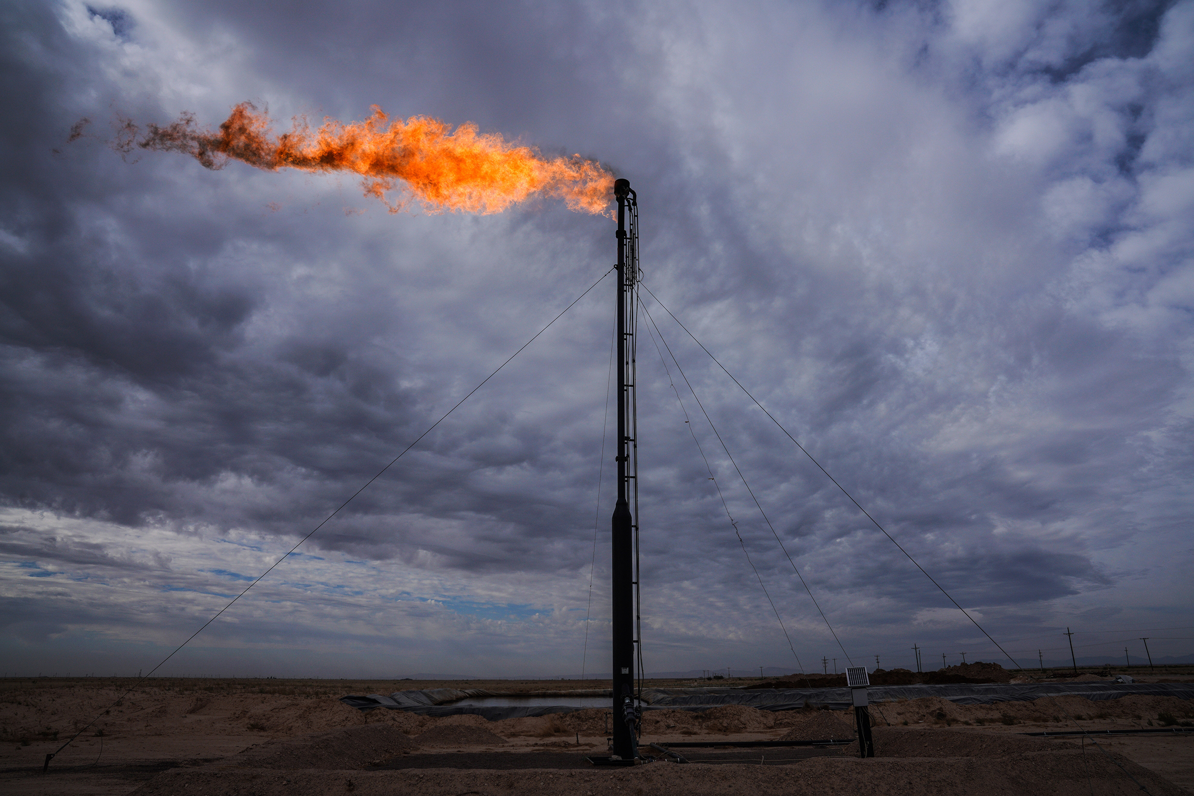 A gas flare shown here in May 2018 burns off excess gas in Midland, Texas, part of the Permian Basin, where an oil boom has remade the landscape. (Benjamin Lowy—Getty Images)