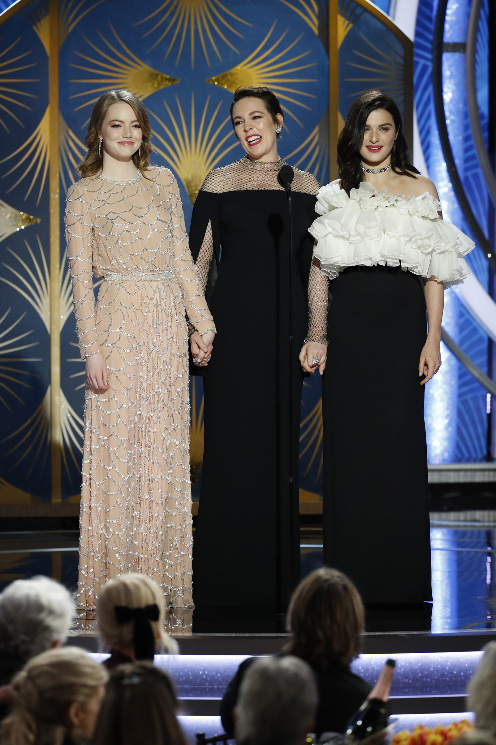 Emma Stone, Olivia Colman, and Rachel Weisz speak onstage during the 76th Annual Golden Globe Awards. (NBCUniversal/Getty Images)