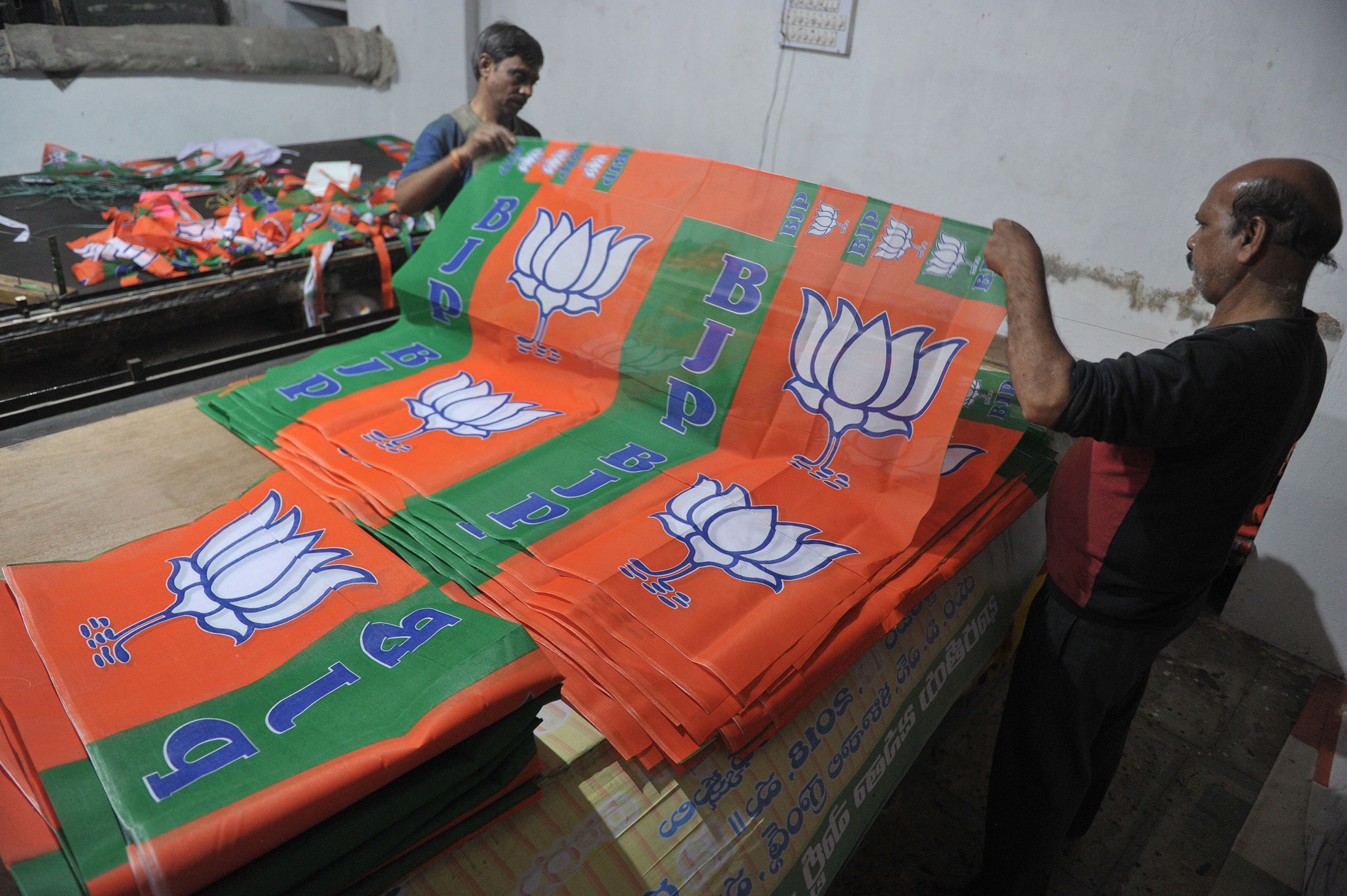 Indian labourers work at a workshop making Bharatiya Janata Party (BJP) election campaign banners for the Telangana state legislative assembly elections in Hyderabad. (Noah Seelam—AFP/Getty ImagesOCT 2018:)