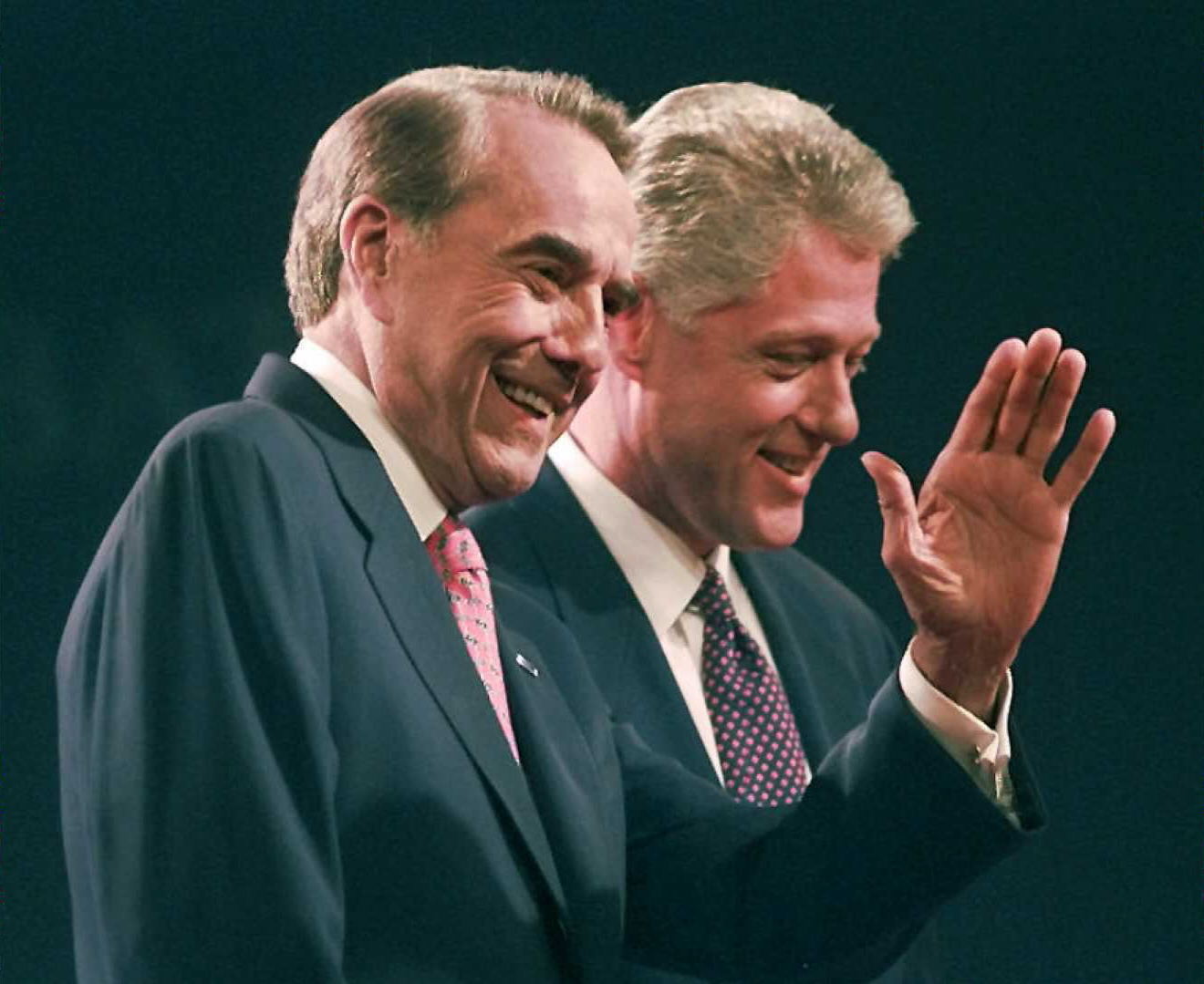 Republican challenger Bob Dole waves to the crowd along side of President Bill Clinton at the conclusion of their first debate in Hartford, CT.