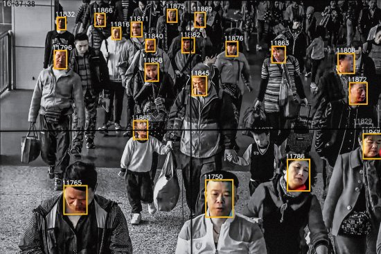 Monitors display a video showing facial recognition software in use at the headquarters of the artificial intelligence company Megvii, in Beijing.