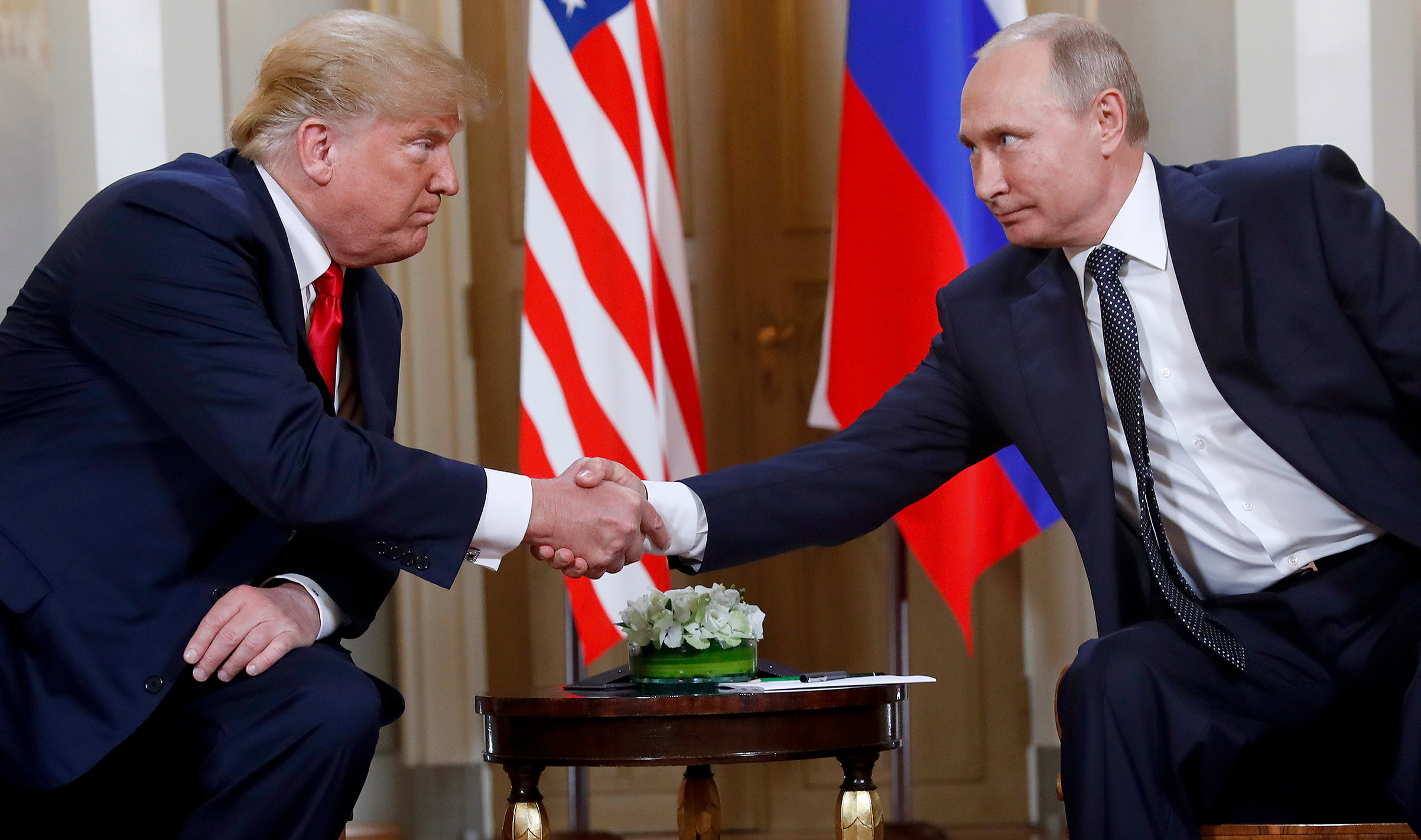 President Donald Trump and Russian President Vladimir Putin shake hands at the beginning of a meeting in Helsinki on July 15, 2018. (Pablo Martinez Monsivais—AP)