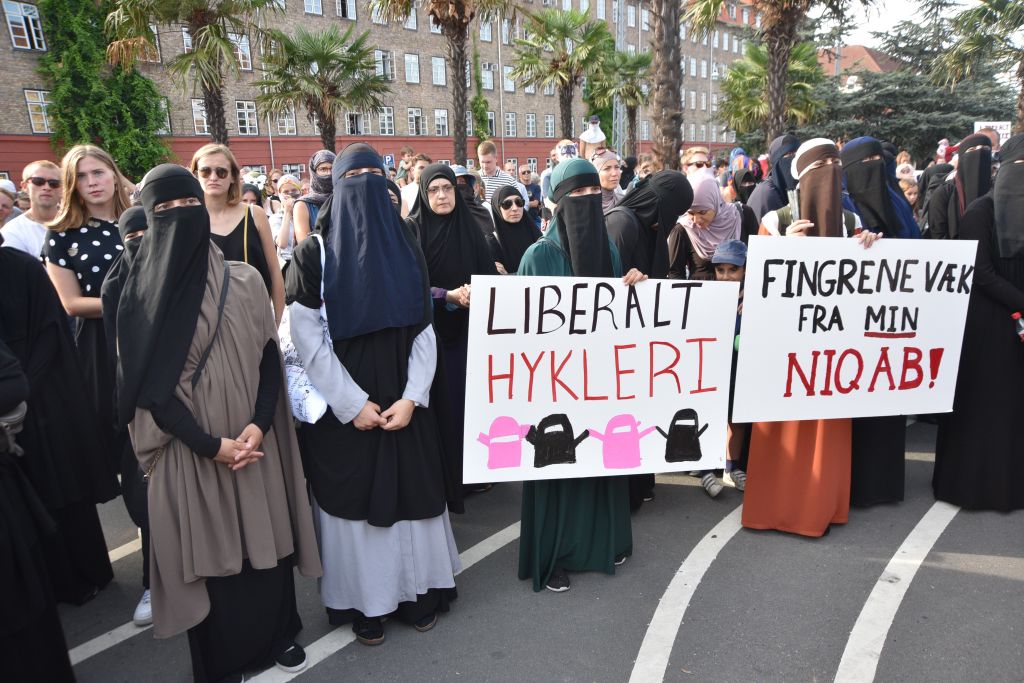 Demonstrators with face veils, hold placards and banners as they gather to protest ban on the wearing of face veils at the Black Square in Copenhagen, Denmark on August 01, 2018. (Davut Colak—Anadolu Agency/Getty Images)