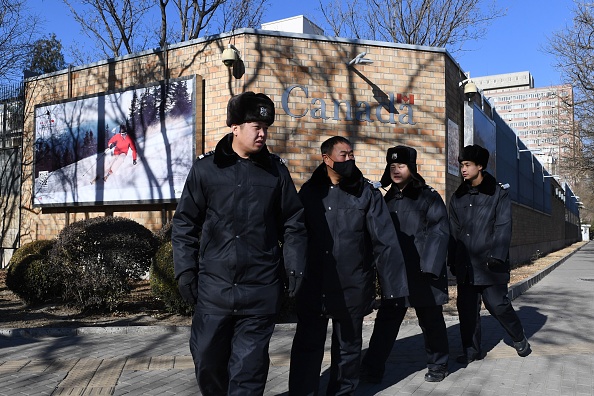 Chinese police patrol in front of the Canadian embassy in Beijing on December 13, 2018. - A second Canadian who had gone missing in China is under investigation on suspicion of "engaging in activities that harm China's national security", state media reported on December 13. Security has been stepped up outside the embassy since Meng Wanzhou, the chief financial officer of Chinese telecom giant Huawei, was arrested in Canada, at Washington's request. (Photo by GREG BAKER / AFP)        (Photo credit should read GREG BAKER/AFP/Getty Images)