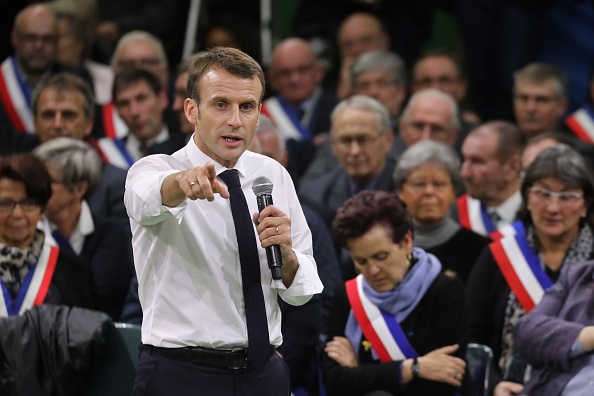 French President Emmanuel Macron (L) gestures as he speaks during meeting gathering some 600 mayors who will relay the concerns aired by residents in their towns and villages in the Normandy city of Grand Bourgtheroulde on January 15, 2019, as part of the official launch of the "great national debate", a central plank of French President Emmanuel Macron bid to turn around his embattled presidency since the yellow vest (gilet jaune) movement protests. - The meeting sounds the start of two months of public consultations in towns and villages across the country on four main themes: taxation; France's transition to a low-carbon economy; democracy and citizenship, and the functioning of the state and public services. (Photo by Ludovic MARIN / AFP)        (Photo credit should read LUDOVIC MARIN/AFP/Getty Images)