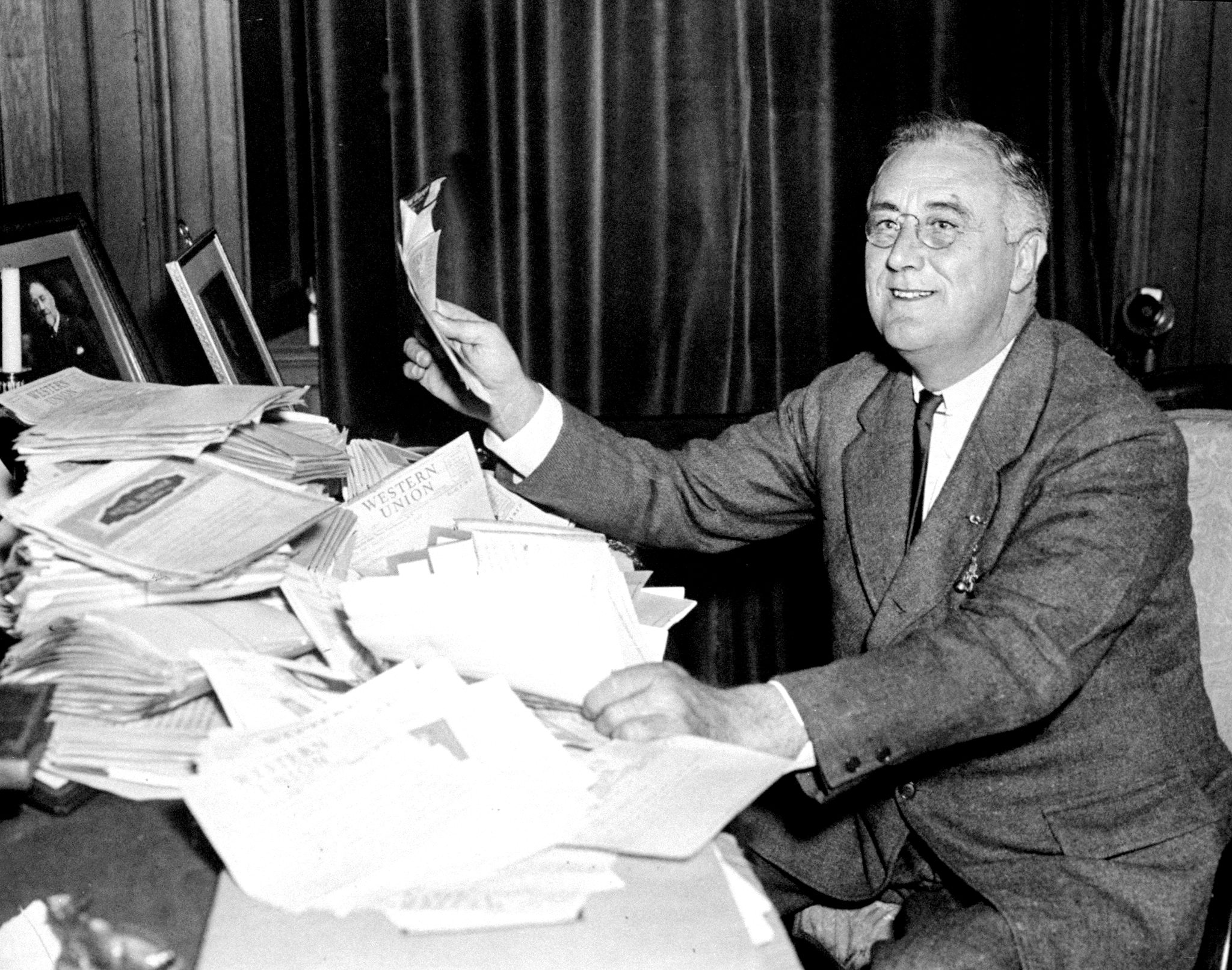 President Franklin D. Roosevelt reads congratulatory telegrams on Nov. 4, 1936, after re-election victory over Alfred Landon. (New York Daily News Archive—Getty Images)