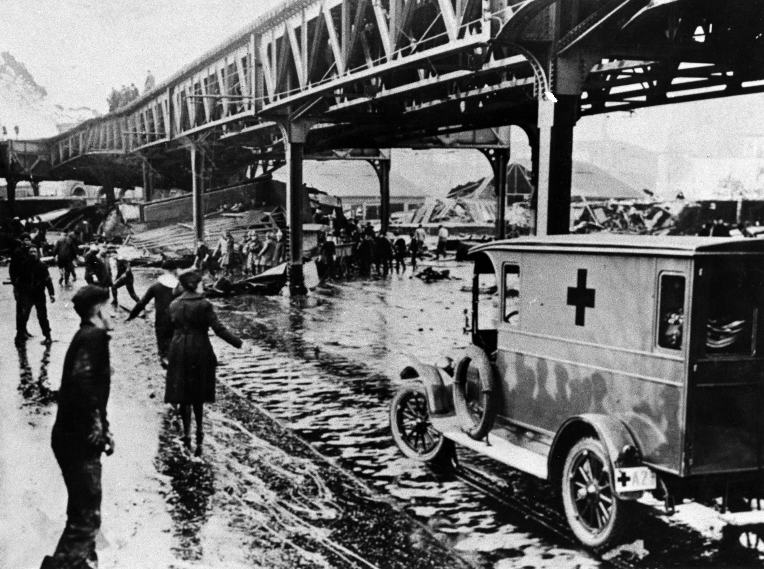 Police, firemen, Red Cross workers, civilian volunteers and cadets from the USS Nantucket training ship berthed nearby rushed to the scene on Jan. 15, 1919, after a giant tank in the North End of Boston collapsed, sending a wave of an estimated 2.3 million gallons of molasses through the streets. (Boston Globe via Getty Images)