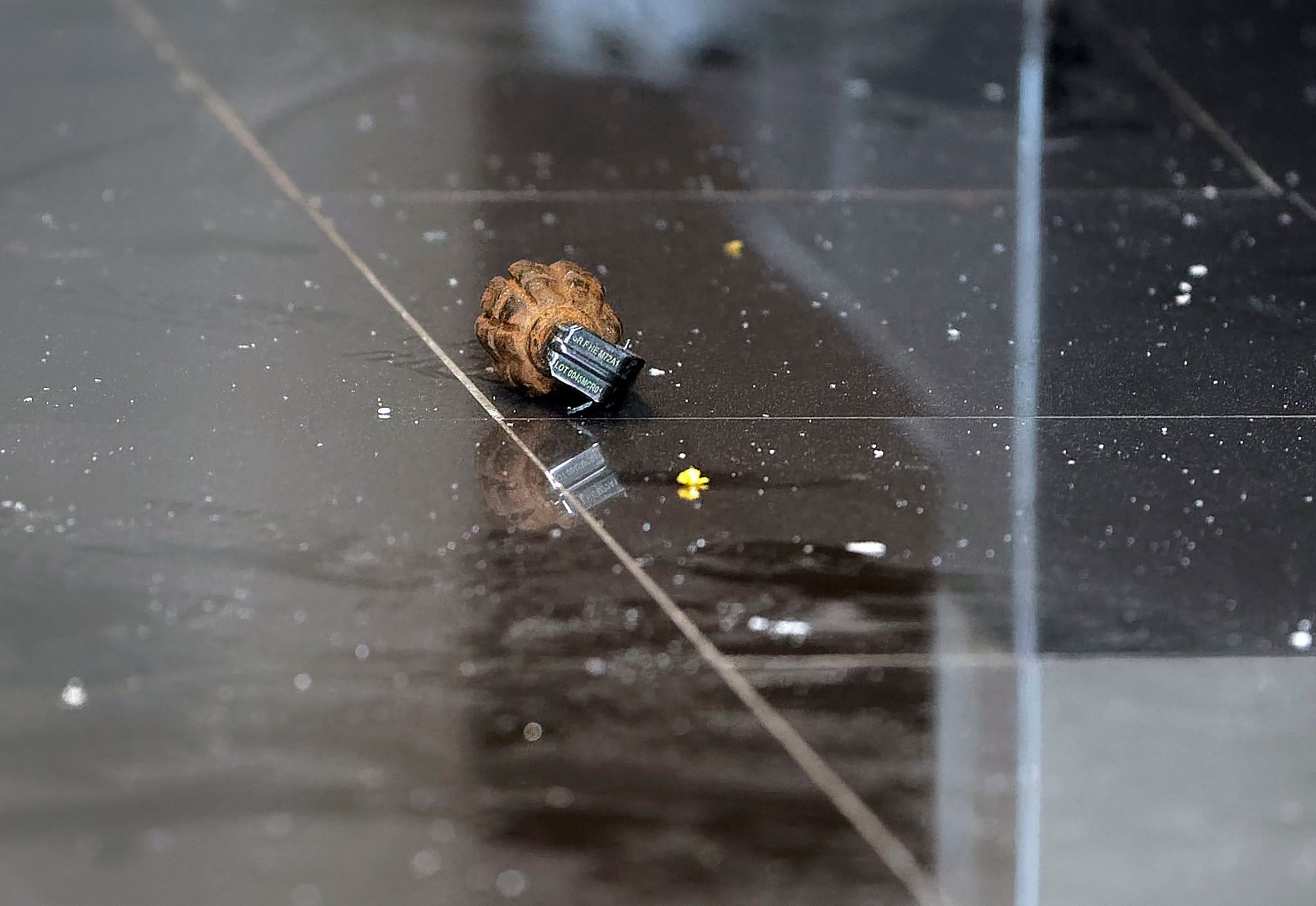 An unexploded grenade lies in a hallway of an upscale hotel complex. (Ben Curtis—AP)