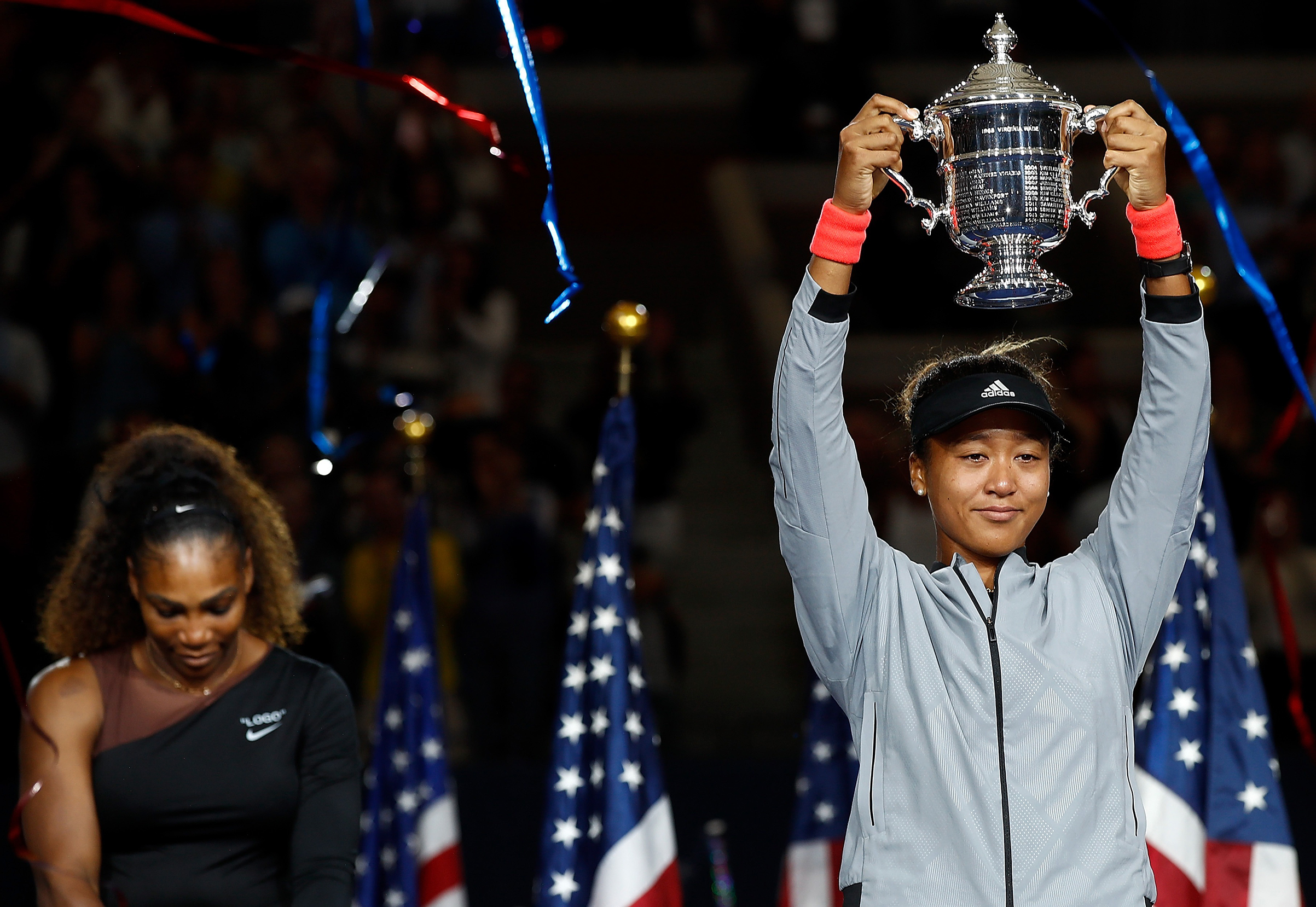At the U.S. Open trophy ceremony, Osaka apologized to booing fans for beating her idol, Serena Williams (Julian Finney—Getty Images)