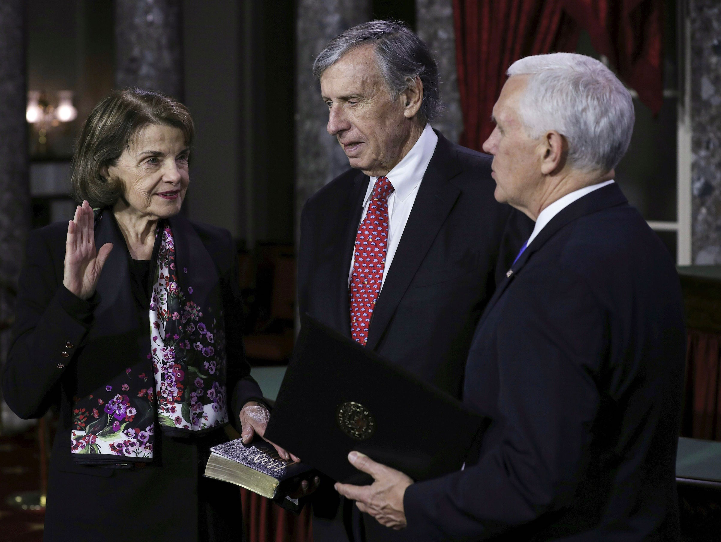 US Senator from California Dianne Feistein (L) flanked by her husband Richard Blum is sworn in by Vice President Mike Pence (R) during the swearing-in re-enactments for recently elected senators in the Old Senate Chamber on Capitol Hill January 3, 2019. (Photo by Alex EDELMAN / AFP)        (Photo credit should read ALEX EDELMAN/AFP/Getty Images) (Alex Edelman—AFP/Getty Images)