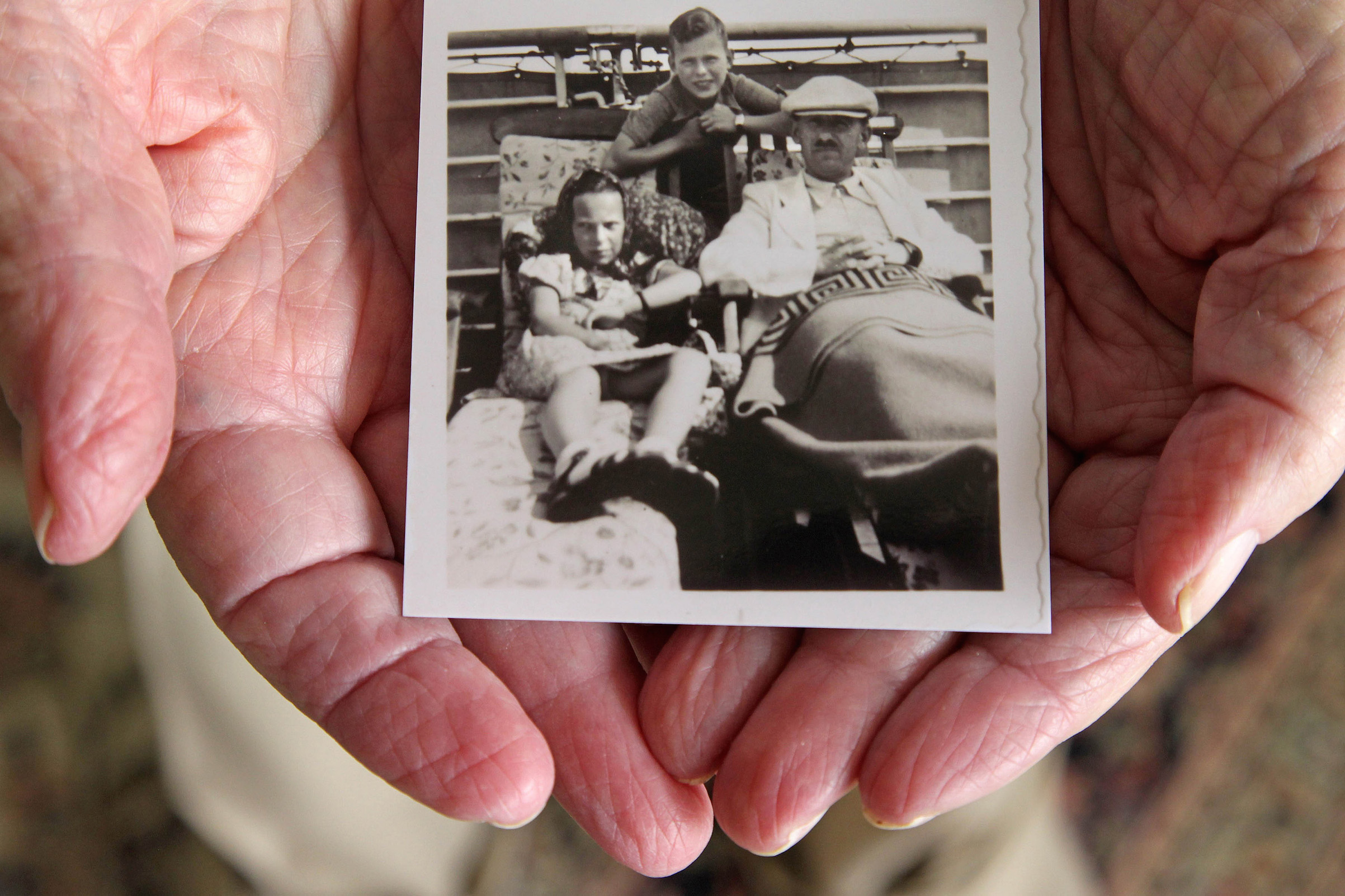 Herbert Karliner, one of the survivors of the 900 Jewish refugees fleeing Hitler who were aboard the ocean liner, St. Louis, in 1939, shares photos and documents from his ordeal on Nov. 18, 2015, in Aventura, Fla. (Carl Juste—TNS via Getty Images)