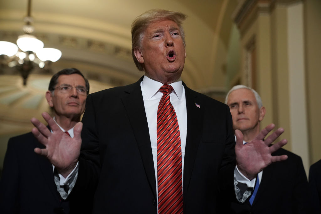U.S. President Donald Trump speaks to members of the media as Sen. John Barrasso and Vice President Mike Pence listen at the U.S. Capitol after the weekly Republican Senate policy luncheon Jan. 9, 2019 in Washington, DC. (Alex Wong—Getty Images)
