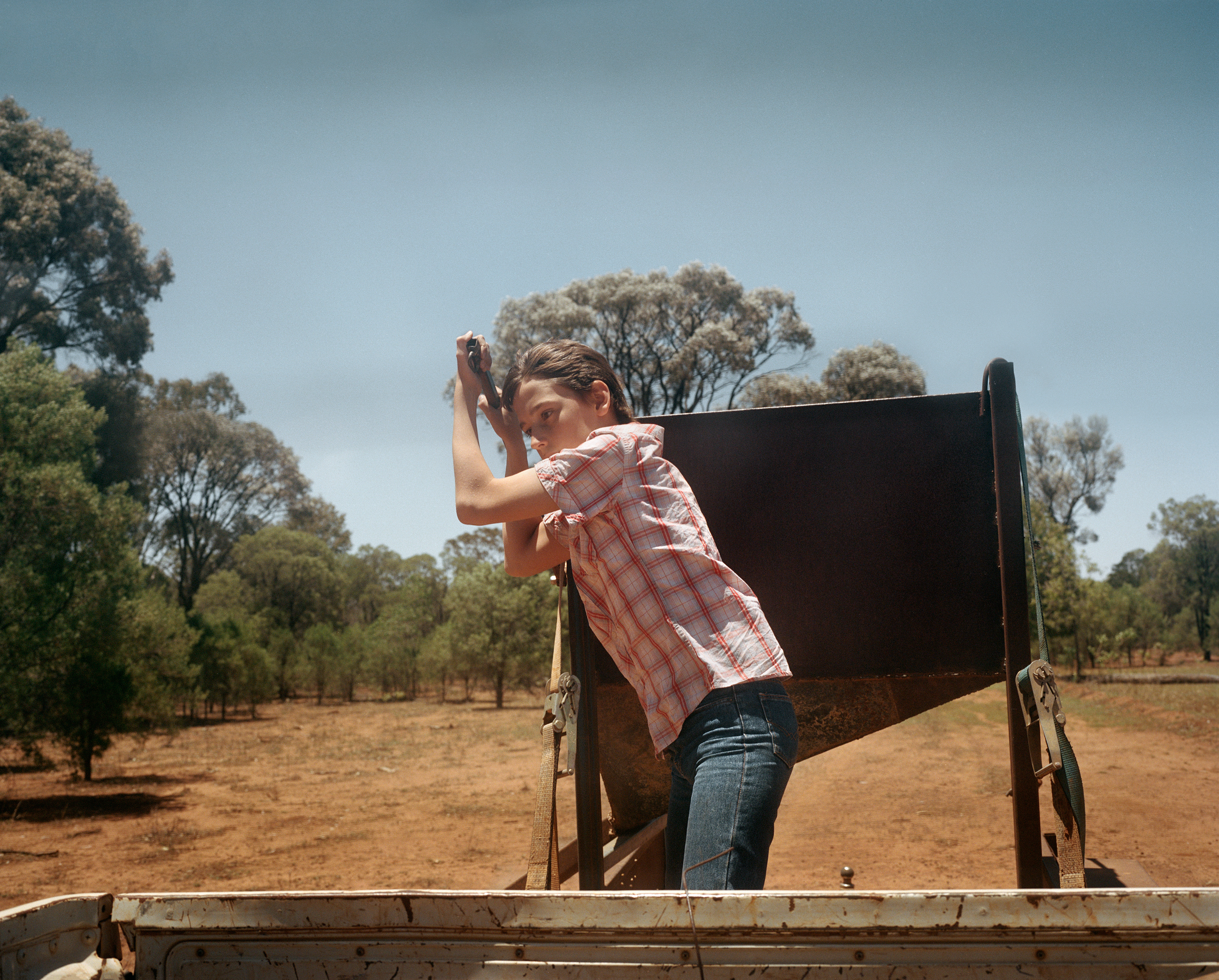 Nicholas Clark, 12, releases feed for sheep on Kandimulla Property in Queensland in November. Without an ability to grow food naturally, Kandimulla owner Kent Morris is forced to buy food to feed his livestock. (Adam Ferguson for TIME)