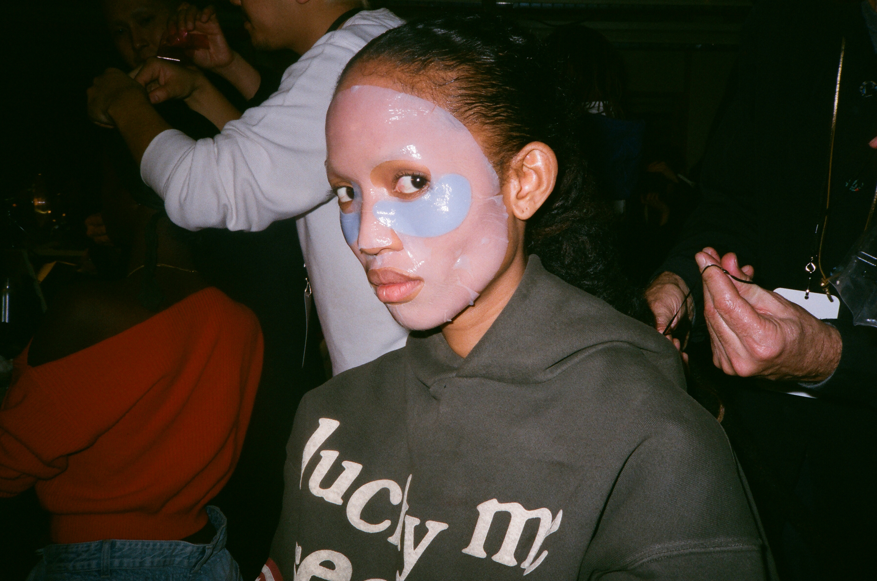 Since Aighewi has already had two different makeup looks today, the makeup team for the Brandon Maxwell Fall/Winter 2019 show put on a face mask to help her skin before applying a new look. (Mary Kang)