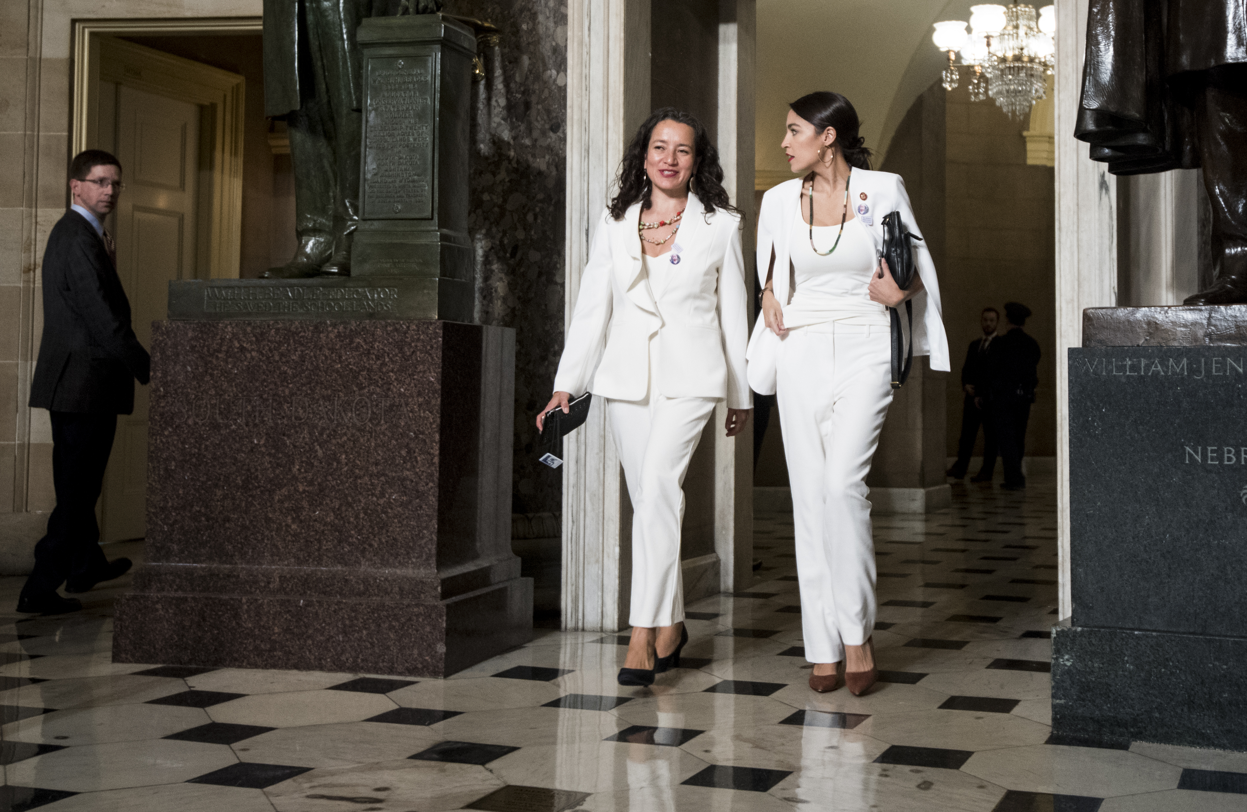 Rep. Alexandria Ocasio-Cortez, right, walks with her State of the Union guest Ana Maria Archila to the House chamber for President Donald Trump's State of the Union address to a joint session of Congress in the Capitol on Feb. 5, 2019. (Bill Clark—CQ-Roll Call/Getty Images)