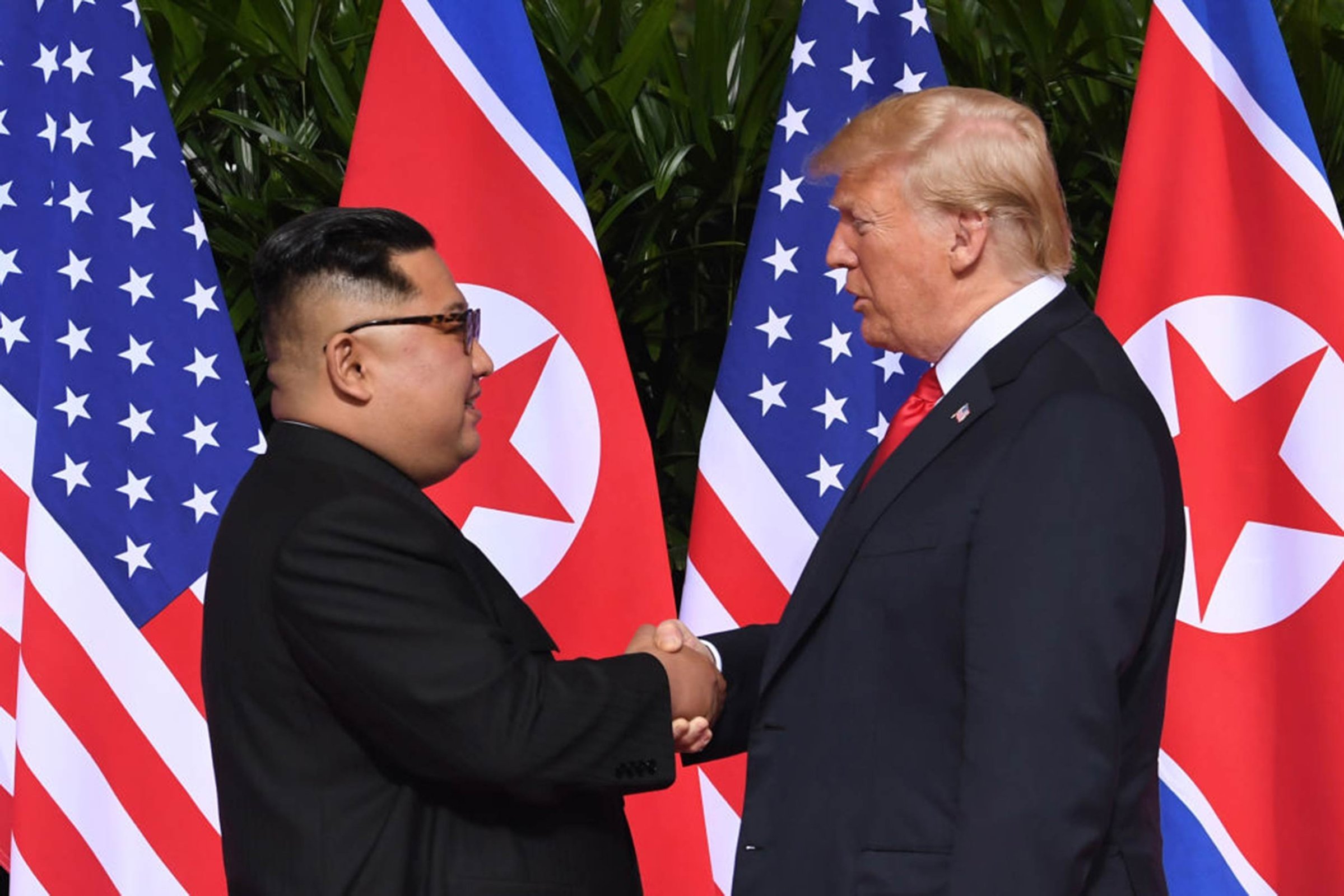 The President of the United States Donald Trump and North Korea's leader Kim Jong Un shake hands