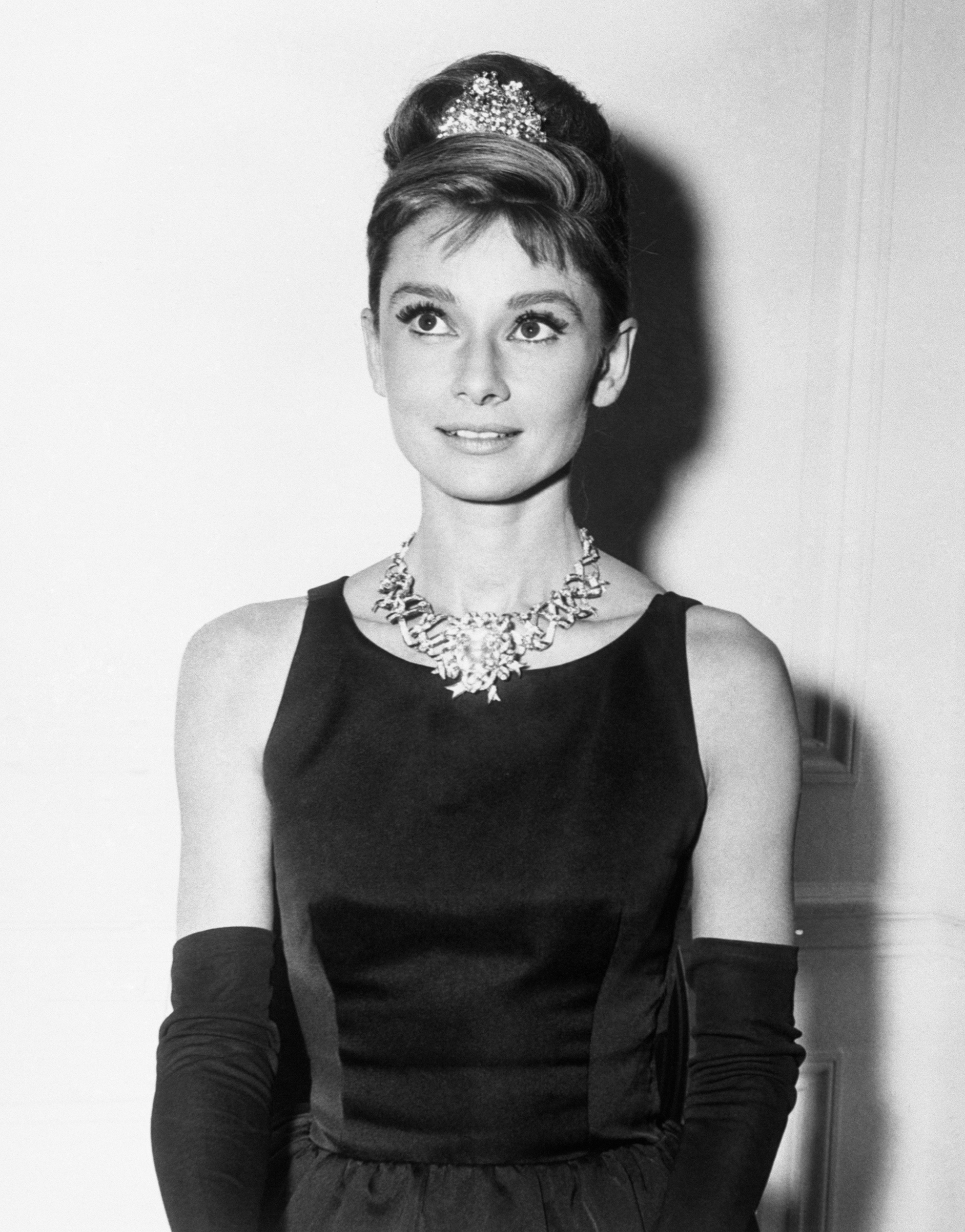 Audrey Hepburn, about to begin filming for Breakfast At Tiffany's, wears one of the store's most expensive diamond necklaces. (Bettmann Archive/Getty Images)