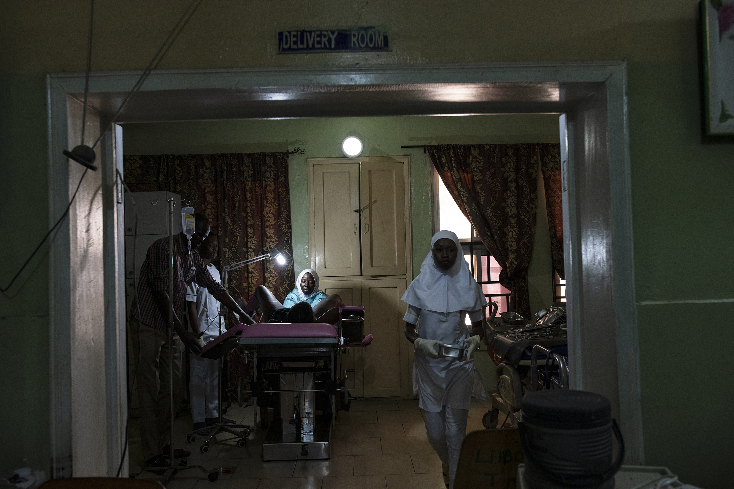 A senior midwife at the State Specialist Hospital in Maiduguri sutures a woman who has just given birth (Lynsey Addario for TIME)