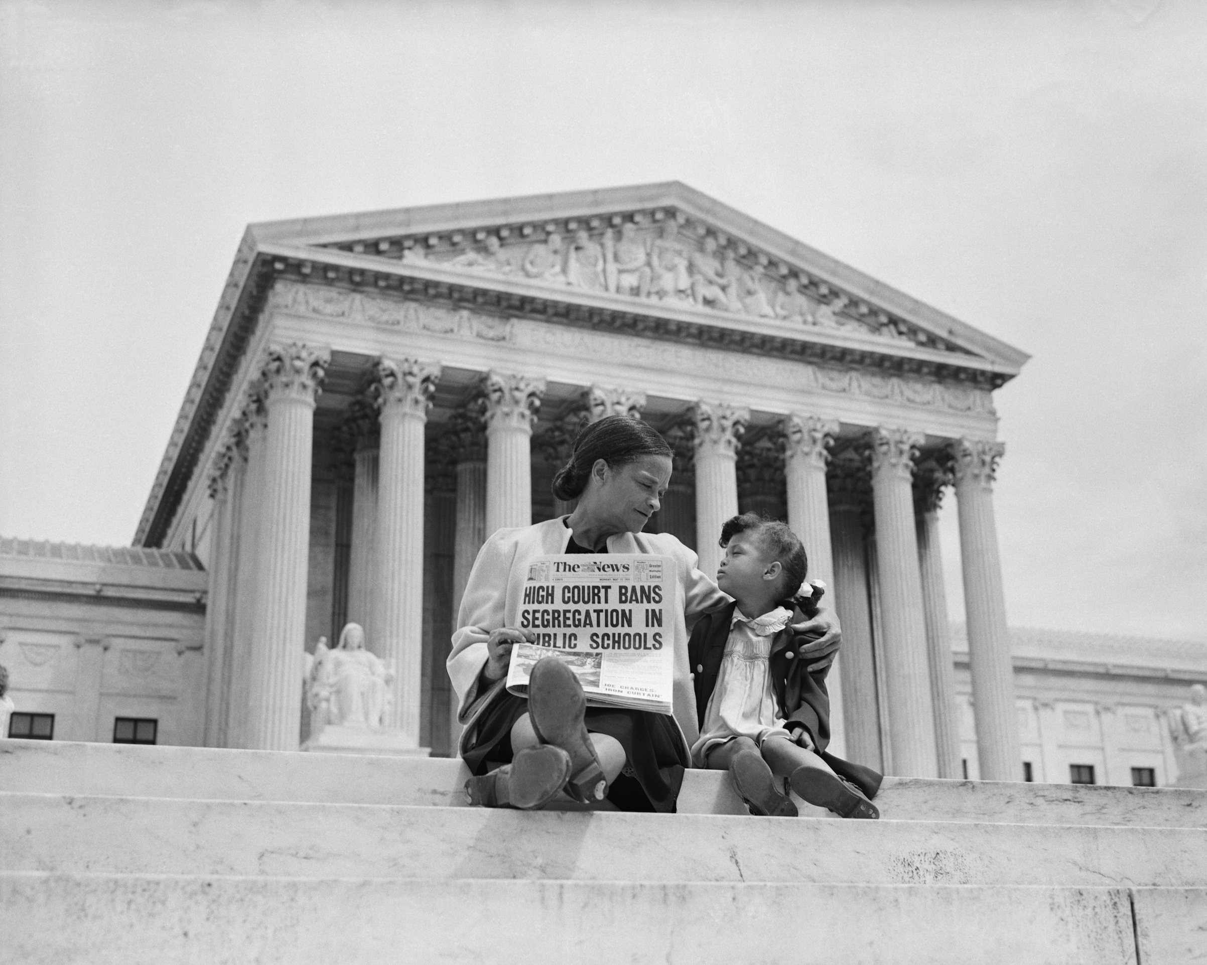 Nettie Hunt and her daughter Nickie sit on the steps of the U.S. Supreme Court in May of 1954. Nettie explains to her daughter the meaning of the high court's ruling in the Brown v. Board of Education case that segregation in public schools is unconstitutional. (Bettmann/Getty Images)