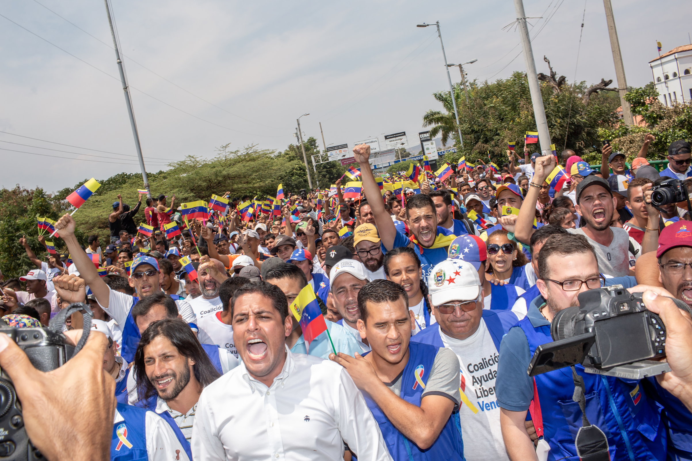 Opposition leaders with volunteers march toward the Venezuelan side of the Simón Bolívar International Bridge, demanding that they be allowed to pass. (Photograph by TIME)