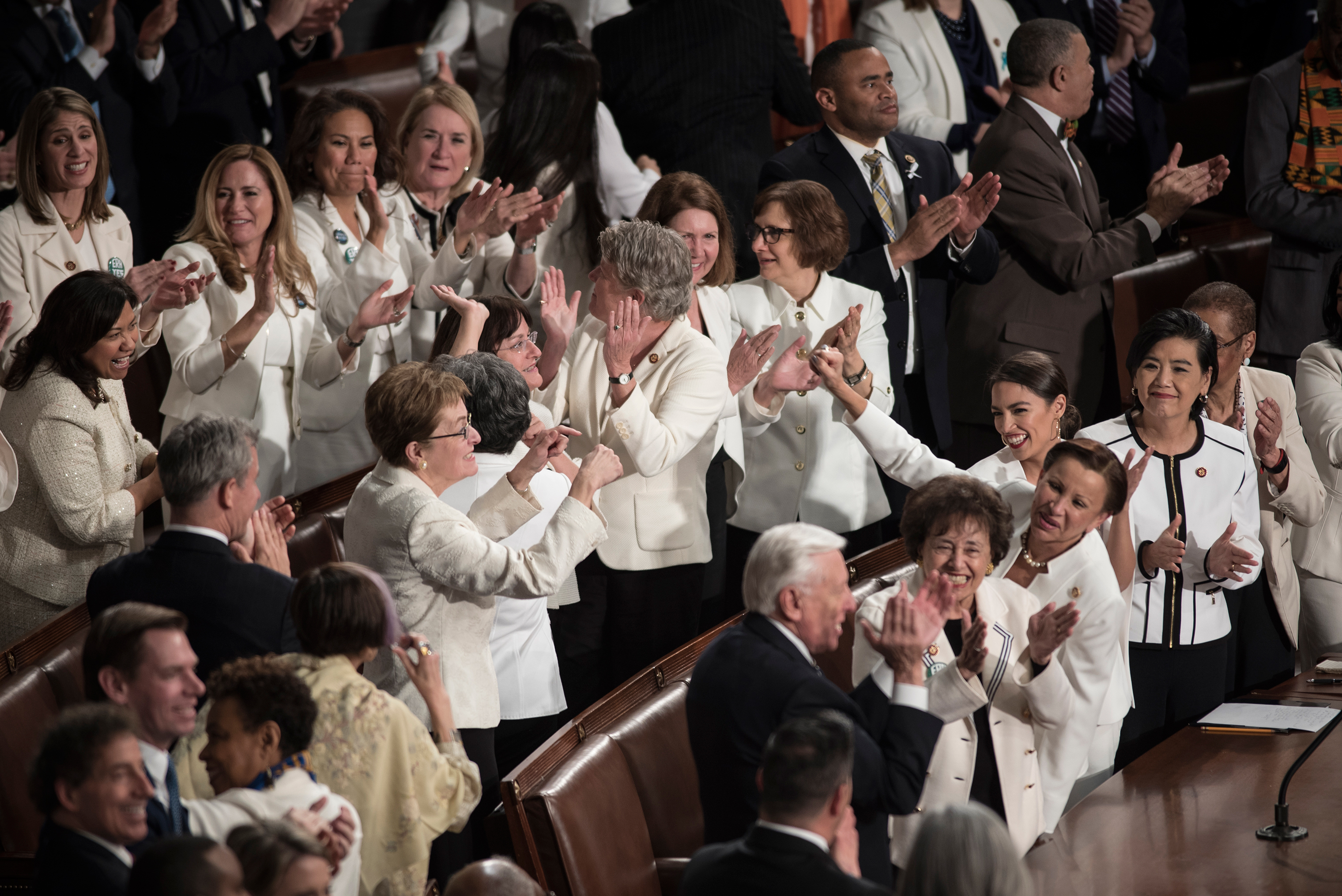 A group of House Democrats cheer as they are acknowledged by President Trump during his Feb. 5 remarks at the State of the Union. (David Butow—Redux for TIME)