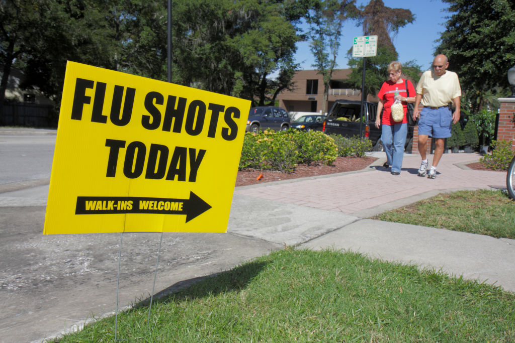 Flu shots sign at the Farmers Market in Winter Park. (Jeff Greenberg&mdash;UIG/Getty Images)