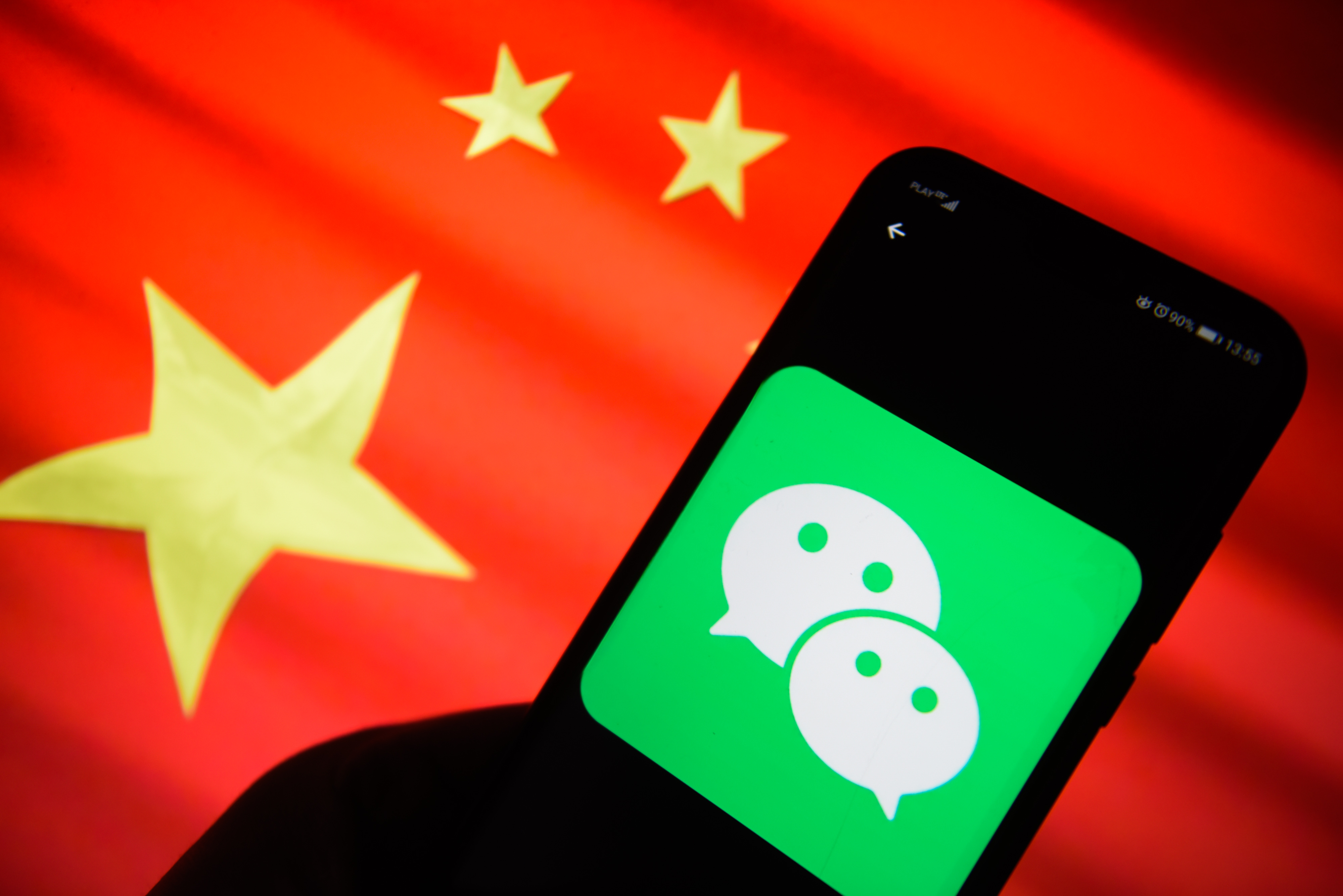 The WeChat logo is seen on a mobile phone with China's flag in the background. (Omar Marques—SOPA Images/LightRocket/Getty Images)