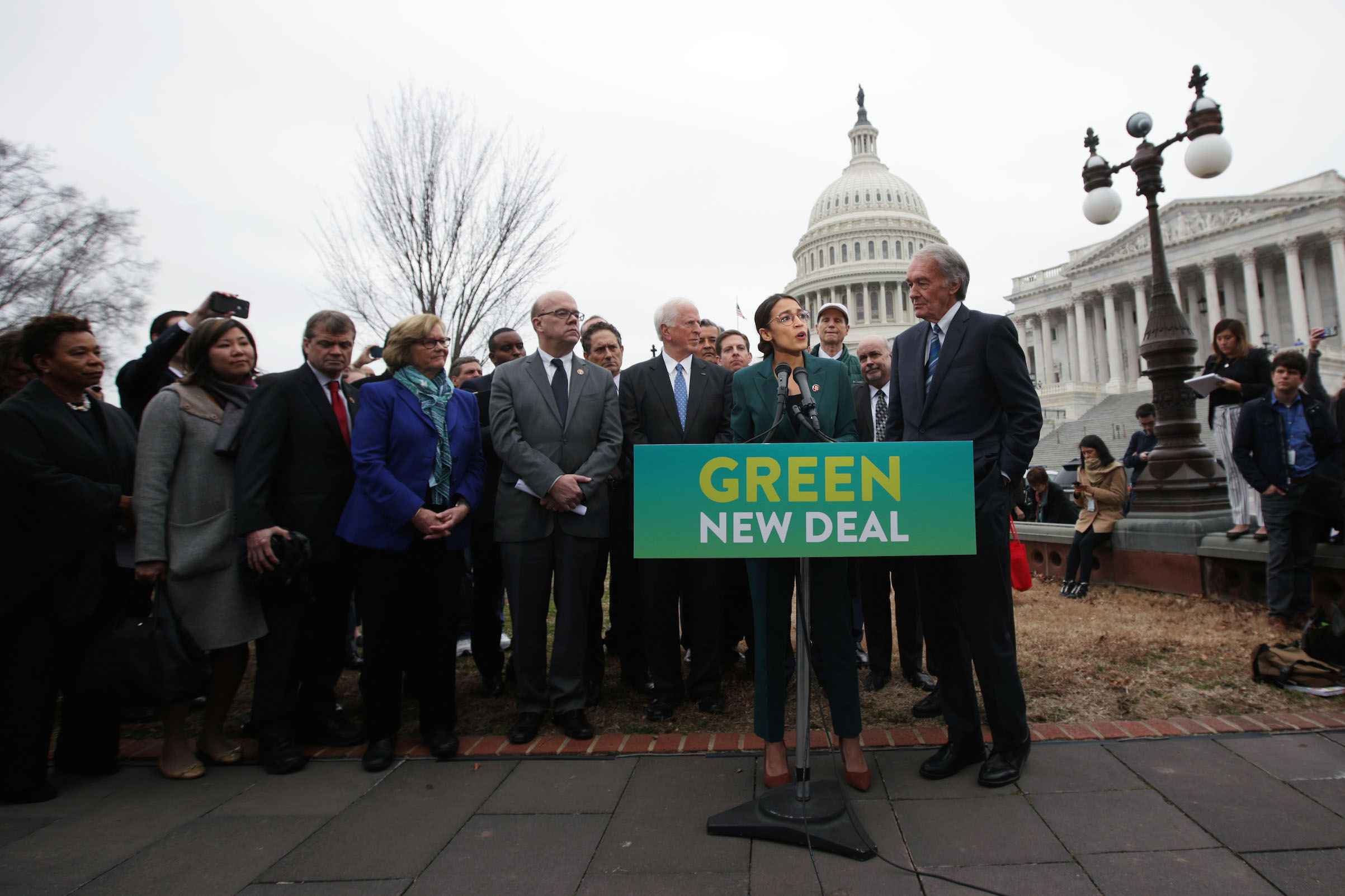 Rep. Alexandria Ocasio-Cortez speaks as Sen. Ed Markey and other Congressional Democrats listen during a news conference in front of the U.S. Capitol in Washington, on Feb. 7, 2019. Sen. Markey and Rep. Ocasio-Cortez held a news conference to unveil their Green New Deal resolution. (Alex Wong—Getty Images)