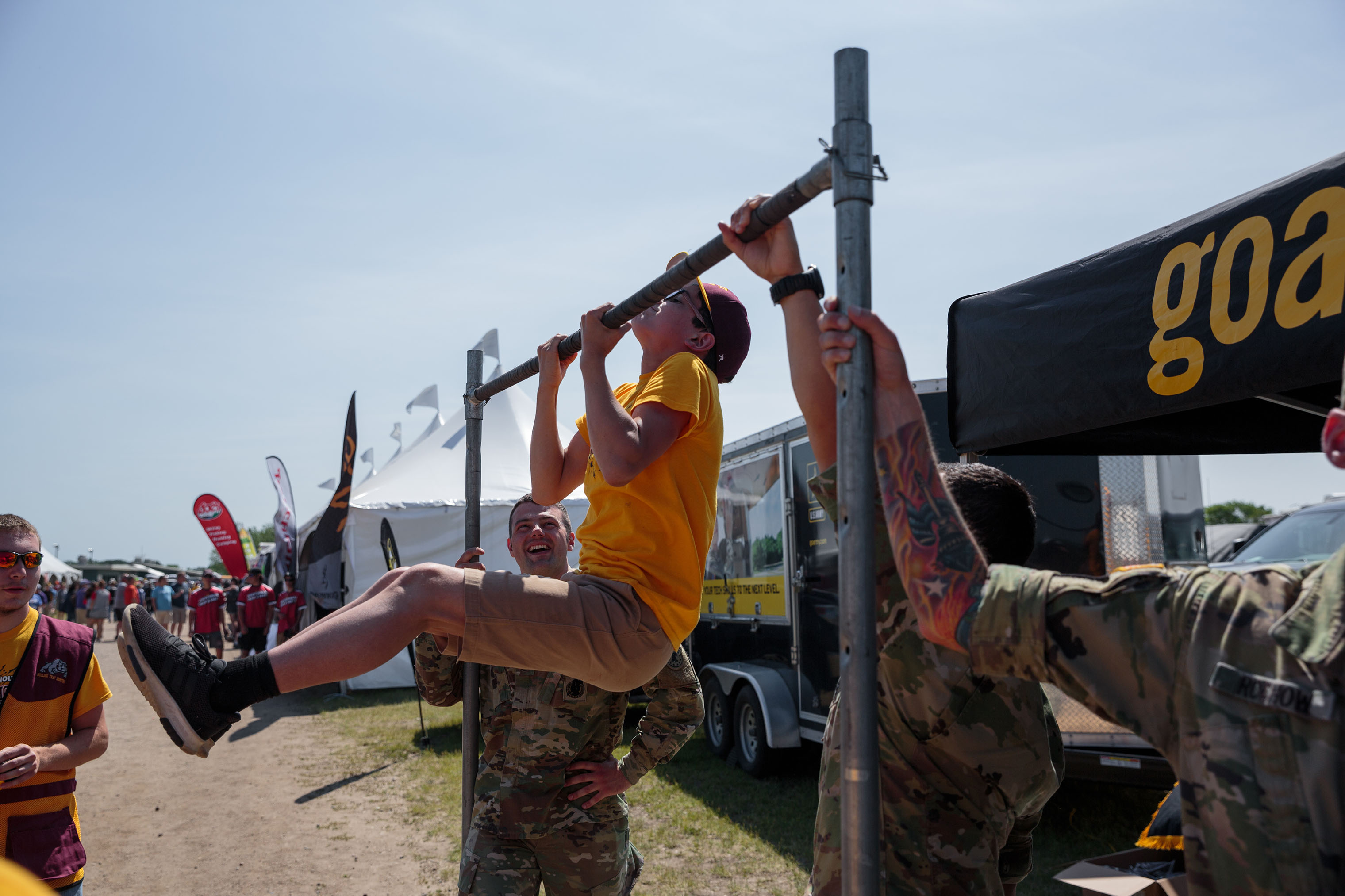 Students participate in a pull-up challenge offered by the "Go-Army" vendor tent at the annual trap shooting championship. (Sarah Blesener for TIME)