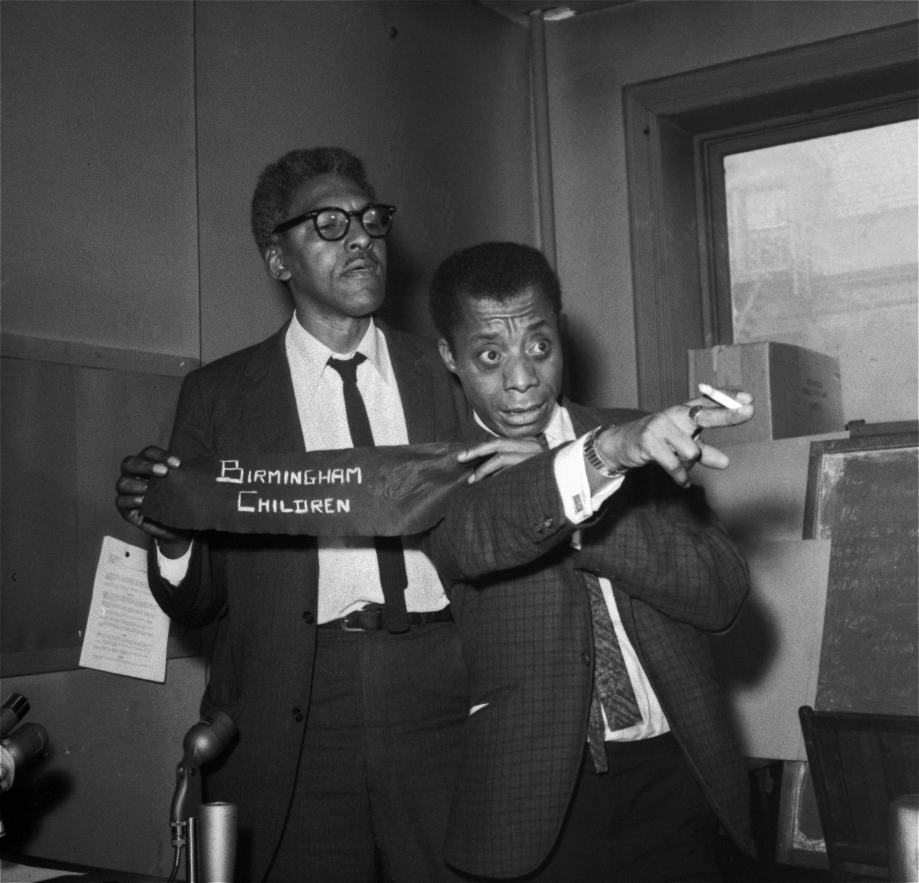 James Baldwin, right, and Bayard Rustin, deputy director of the March on Washington, discussing the 16th Street Baptist Church bombing that killed four young African-American girls in Birmingham, Ala., during a news conference in New York three days later, on Sept. 18, 1963. Rustin is holding an armband that people would be wearing at an upcoming rally organized as a day of mourning for the victims. (AP)