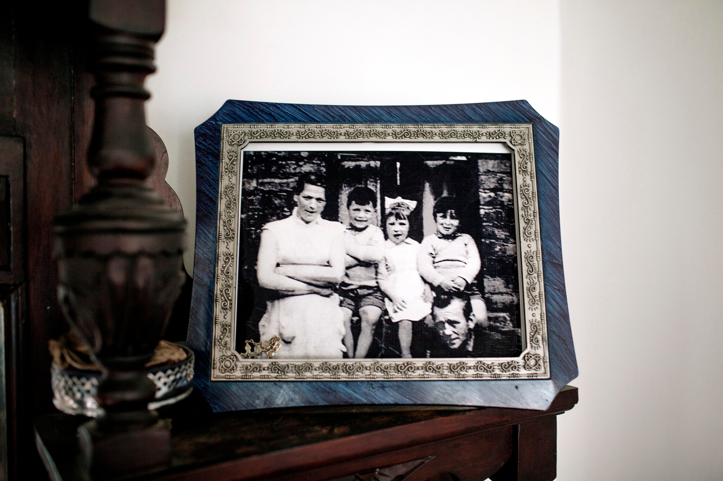 A portrait of the McConville family in the home of Helen McKendry, daughter of Jean McConville (left), a widowed Belfast mother of 10 who was killed in 1972.