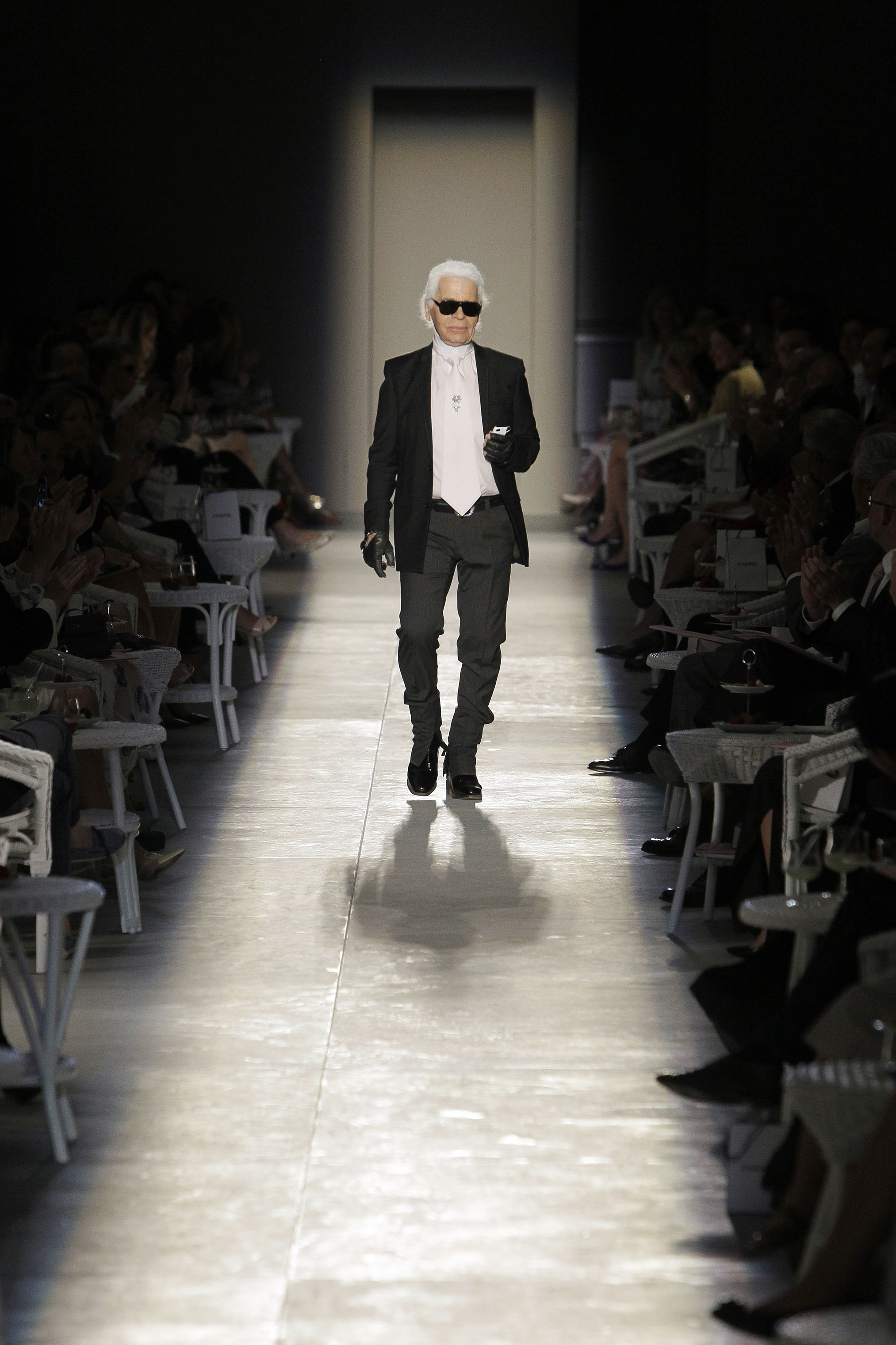 In this July 3, 2012 photo, Karl Lagerfeld acknowledges the applause of the audience at the end of his Women's Fall Winter 2013 haute couture fashion collection in Paris. (Francois Mori—AP)
