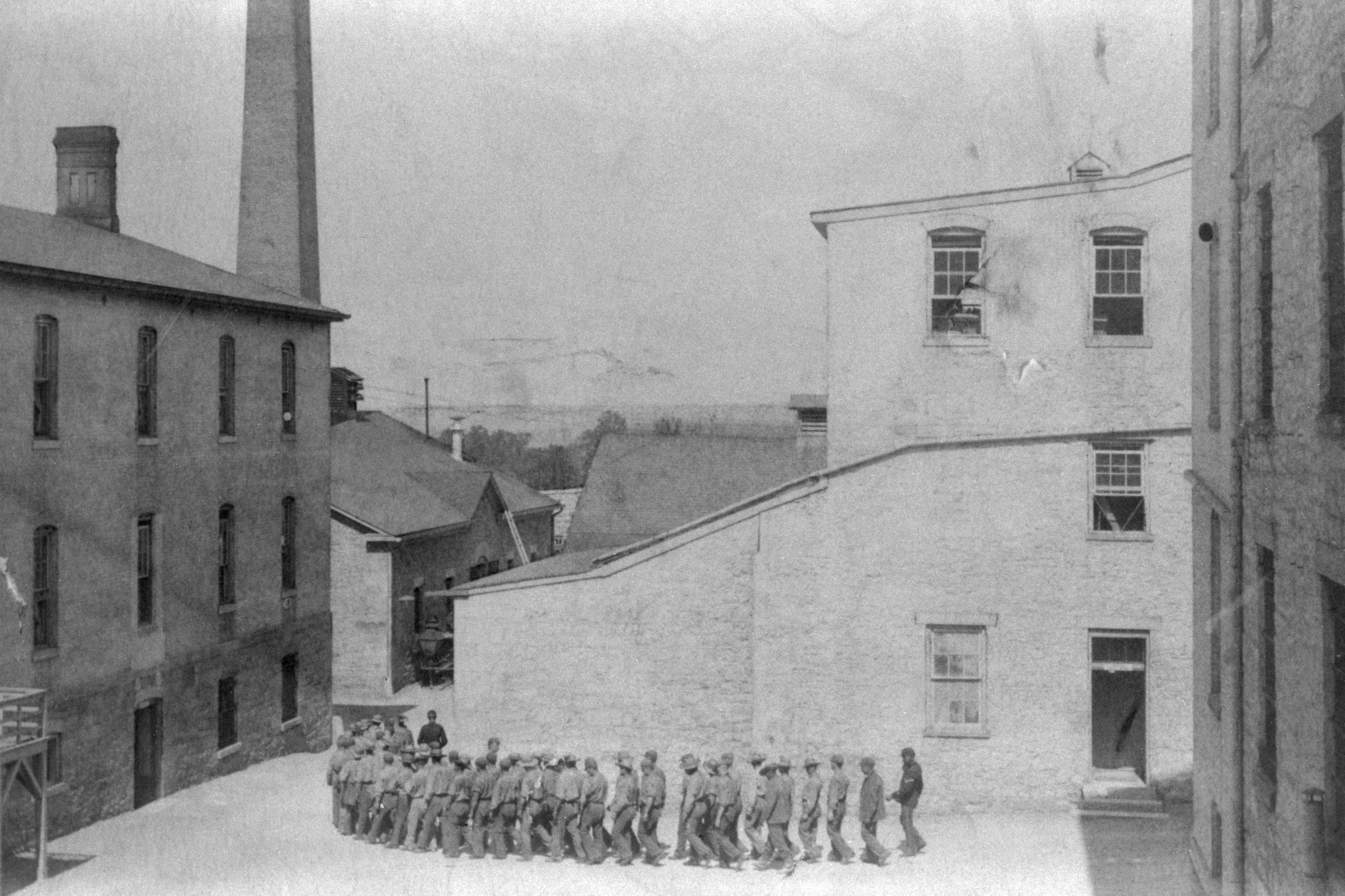 Prisoners at Fort Leavenworth Penetentiary march in a line to the mess hall for dinner ca. 1890s. (Historical/Corbis/Getty Images)