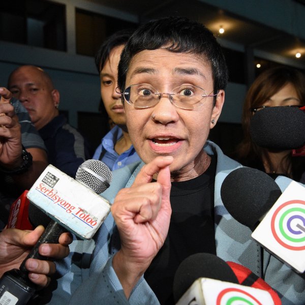 Journalist Maria Ressa speaks to the media as she arrives at the National Bureau of Investigation headquarters