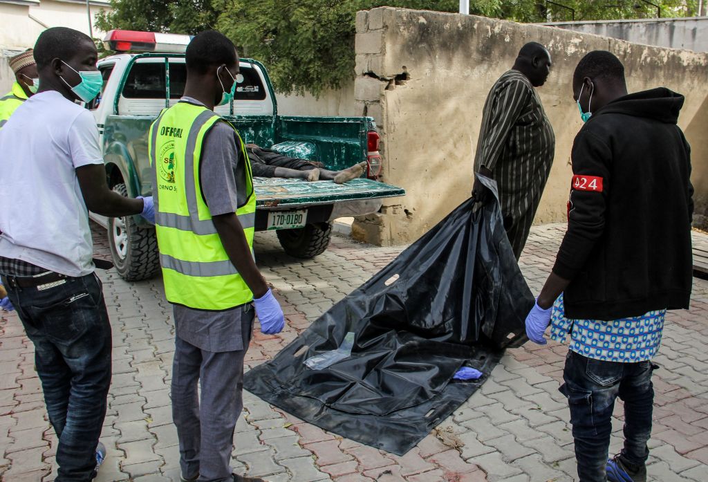 Officials load the body of a victim to the general hospital mortuary on a street of the Jiddari Polo neighbourhood of the northeastern Nigeria city of Maiduguri, on Februray 16, 2019 where Boko Haram fighters shot residents while two suicide bombers blew themselves up, killing eight people. (Audu Marte—AFP/Getty Images)