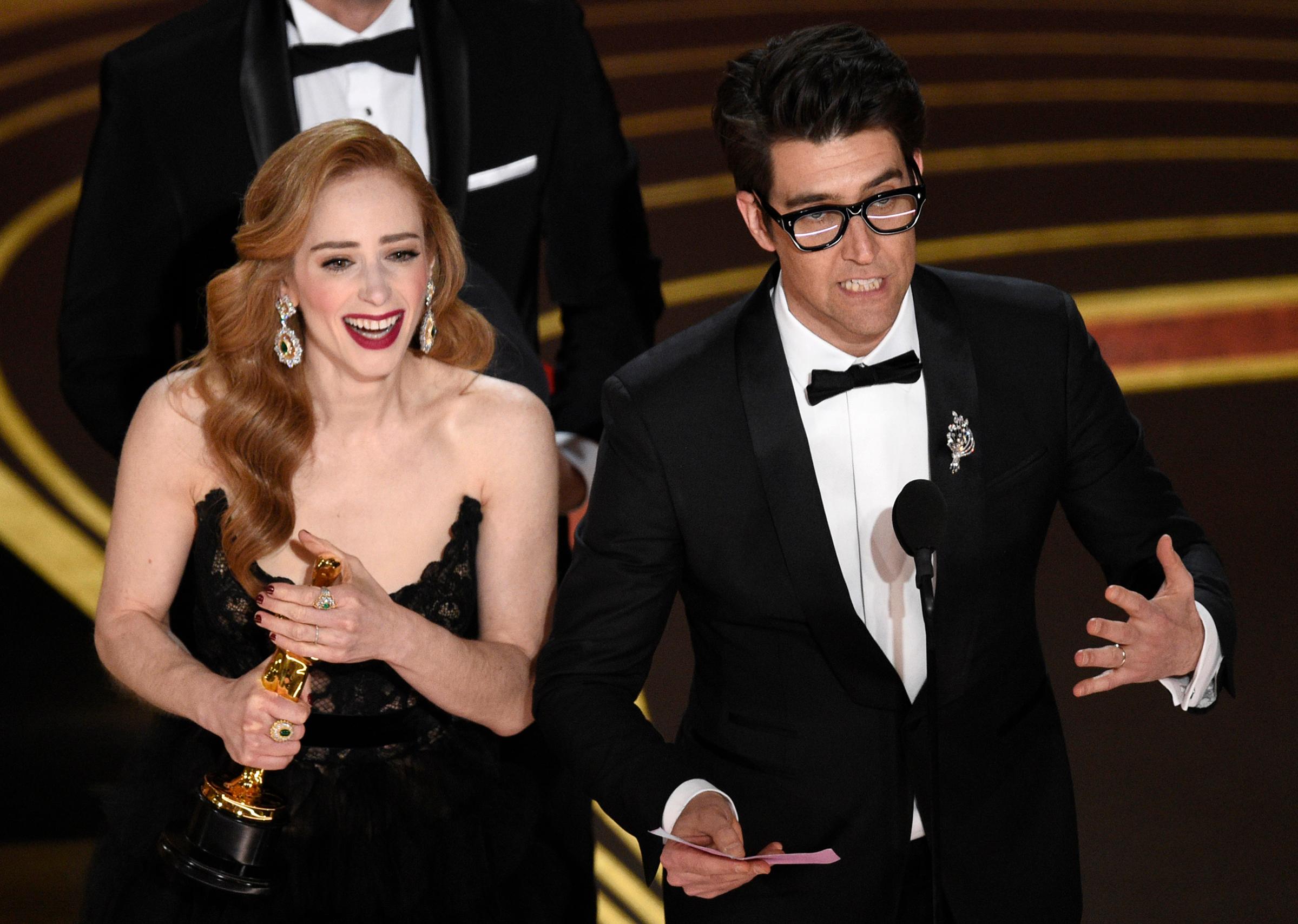 Guy Nattiv, right, and Jaime Ray Newman accept the award for best live action short film for "Skin" at the Oscars on Feb. 24, 2019.