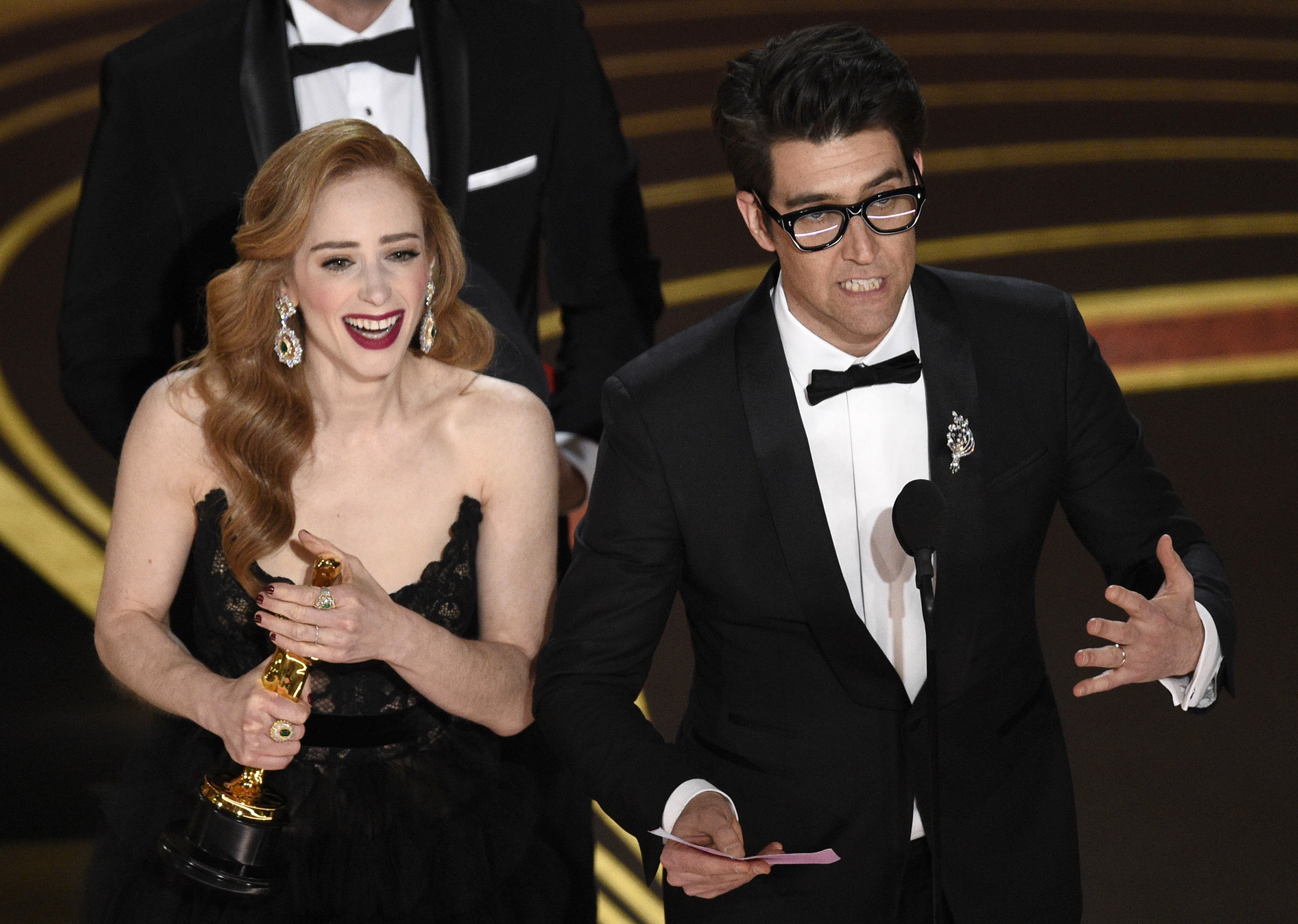 Guy Nattiv, right, and Jaime Ray Newman accept the award for best live action short film for "Skin" at the Oscars on Feb. 24, 2019. (Chris Pizzello—Invision/AP)