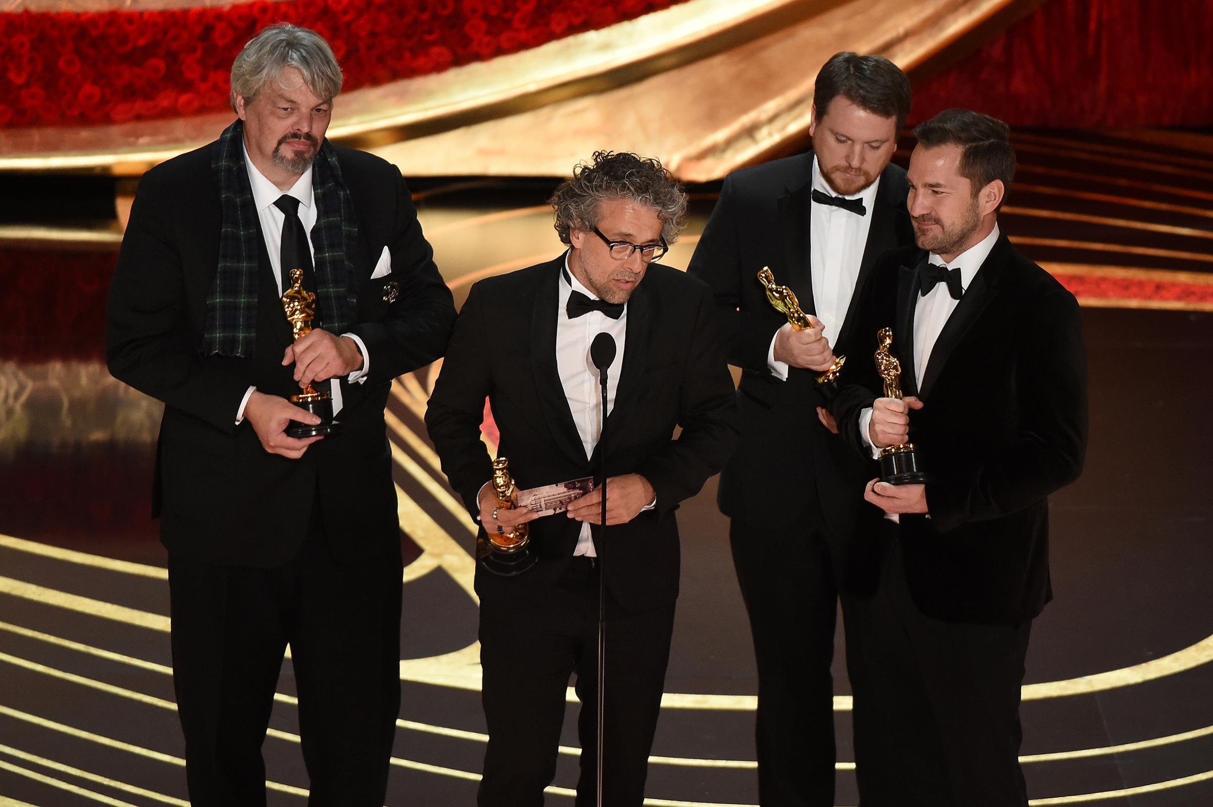 Best Visual Effects nominees for "First Man" Paul Lambert, Ian Hunter, Tristan Myles and J.D. Schwalm accept the award for Best Visual Effects during the 91st Annual Academy Awards at the Dolby Theatre in Hollywood, California on Feb. 24, 2019.