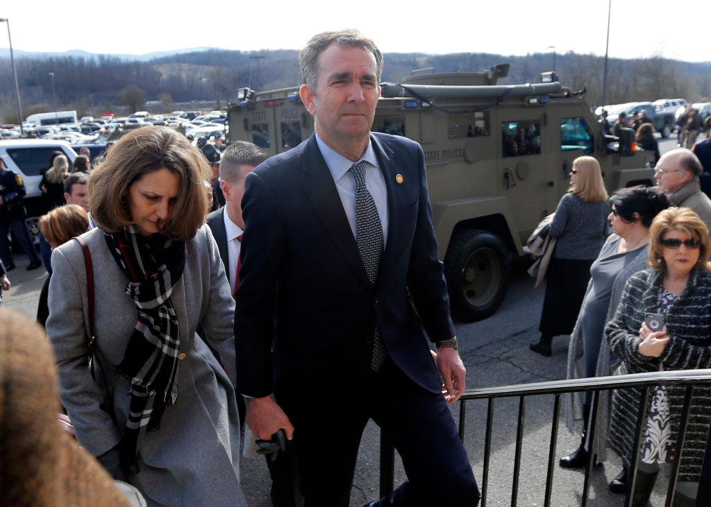 Virginia Gov. Ralph Northam, left,  and his wife Pam, left, leave the funeral of fallen Virginia State Trooper Lucas B. Dowell after the church service for the funeral at the Chilhowie Christian Church on Feb. 9, 2019 in Chilhowie, Virginia. In an interview with the Washington Post on Feb. 9, 2019 he said he will not resign but he will use the rest of his term to work on racial "equity". (Pool—Getty Images)