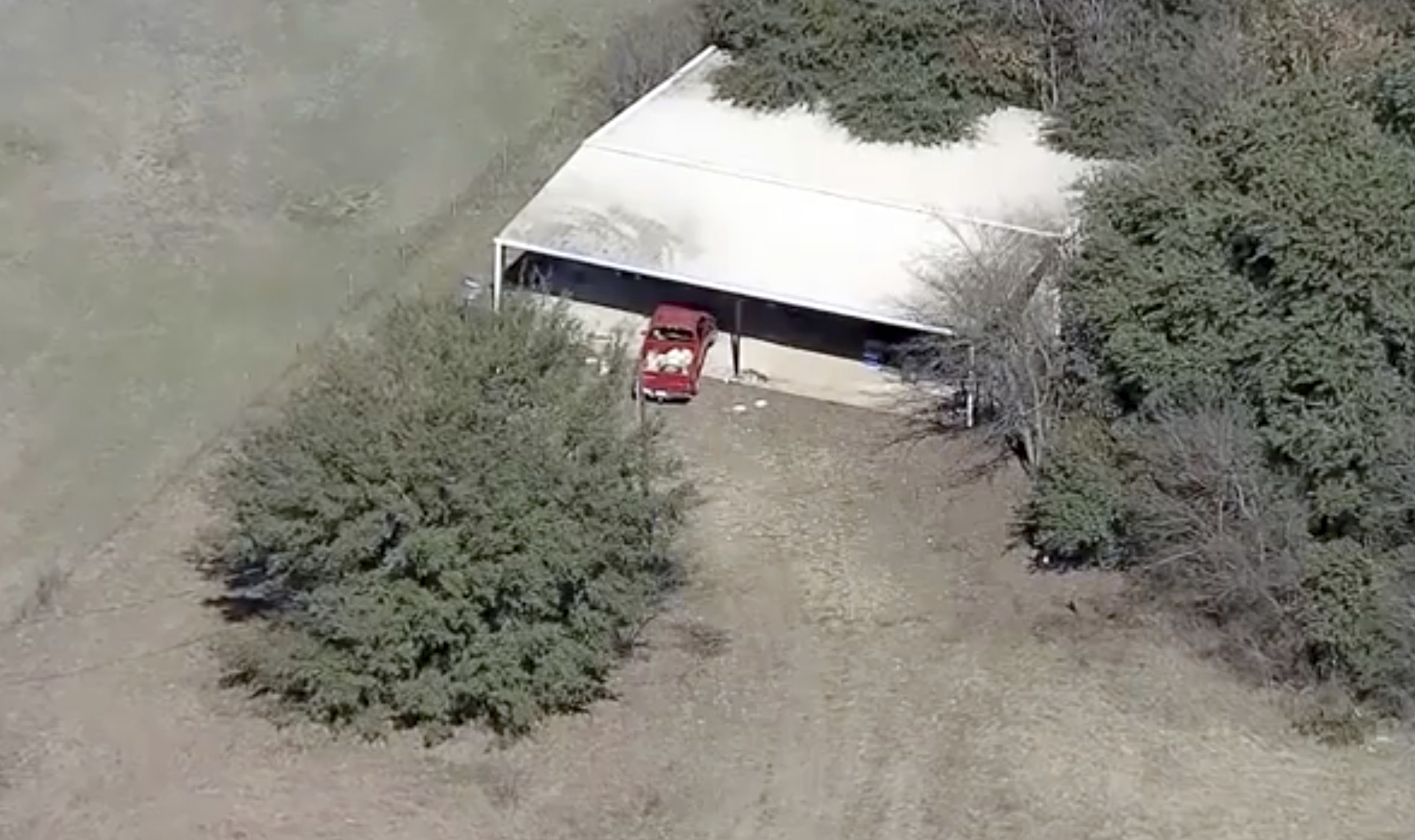 This aerial image provided by KDFW-FOX4 News shows part of the property where deputies found two young, malnourished children locked together in a dog cage near Rhome, Texas about 20 miles (32 kilometers) northwest of Fort Worth. A Texas sheriff says, Tuesday, Feb. 12, 2019, deputies responding to a domestic disturbance at a home discovered two young, malnourished children locked together in a dog cage while two others also were found malnourished. (AP)