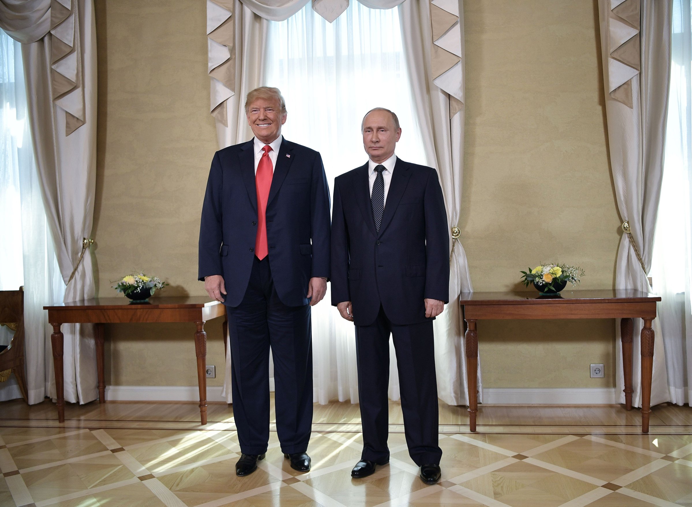 US President Donald Trump and Russia's President Vladimir Putin pose ahead a meeting in Helsinki, on July 16, 2018.