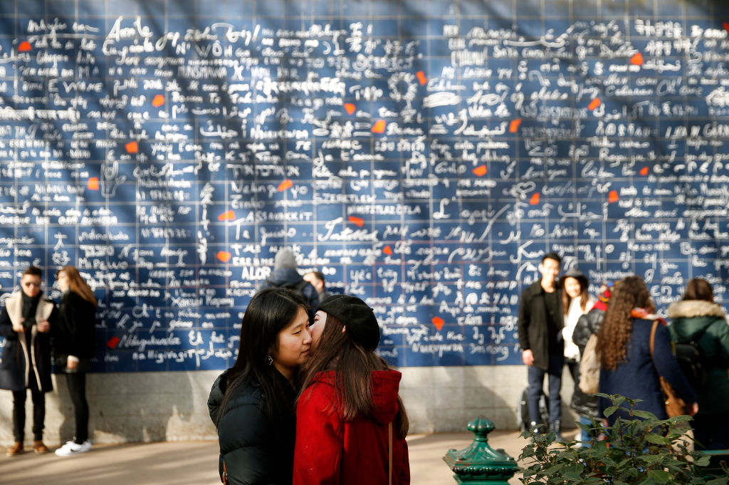 A couple kiss in front of « The wall of I love you » (Le mur des je t’aime) on the eve of the Valentine's Day